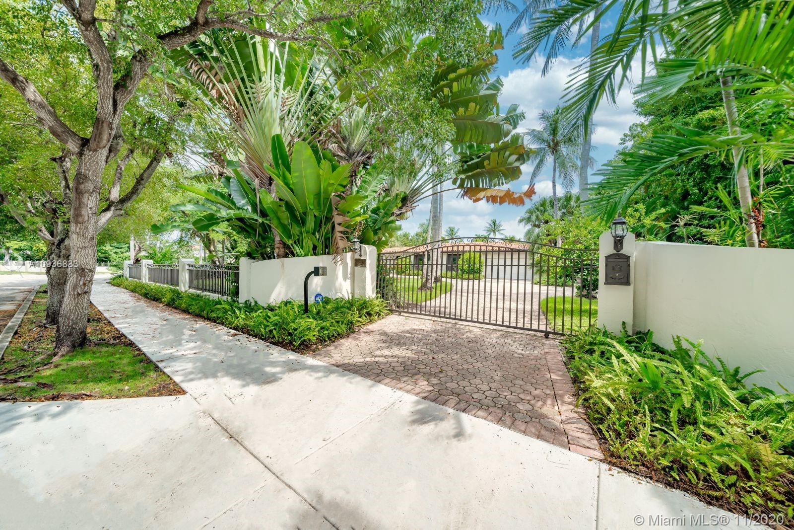 This California style bungalow has a carefree dreamy feeling. Its breeze swept simplicity creates a sense of well-being. 36,750 SF of land and 125 feet of wide bayfront allows you to create your own destination and enjoy each perfect summer day. This home has large living and dining areas, a bright gourmet kitchen and family room, double bayfront master suites + halls of glass filled with brilliant light. Majority of the home has splendid 12 ft ceilings. Large pool, generator and 2-car garage. Located in a lush guard-gated neighborhood with a large waterfront park. Mere minutes from renowned Design District and Wynwood. 10 minutes from Downtown Miami.