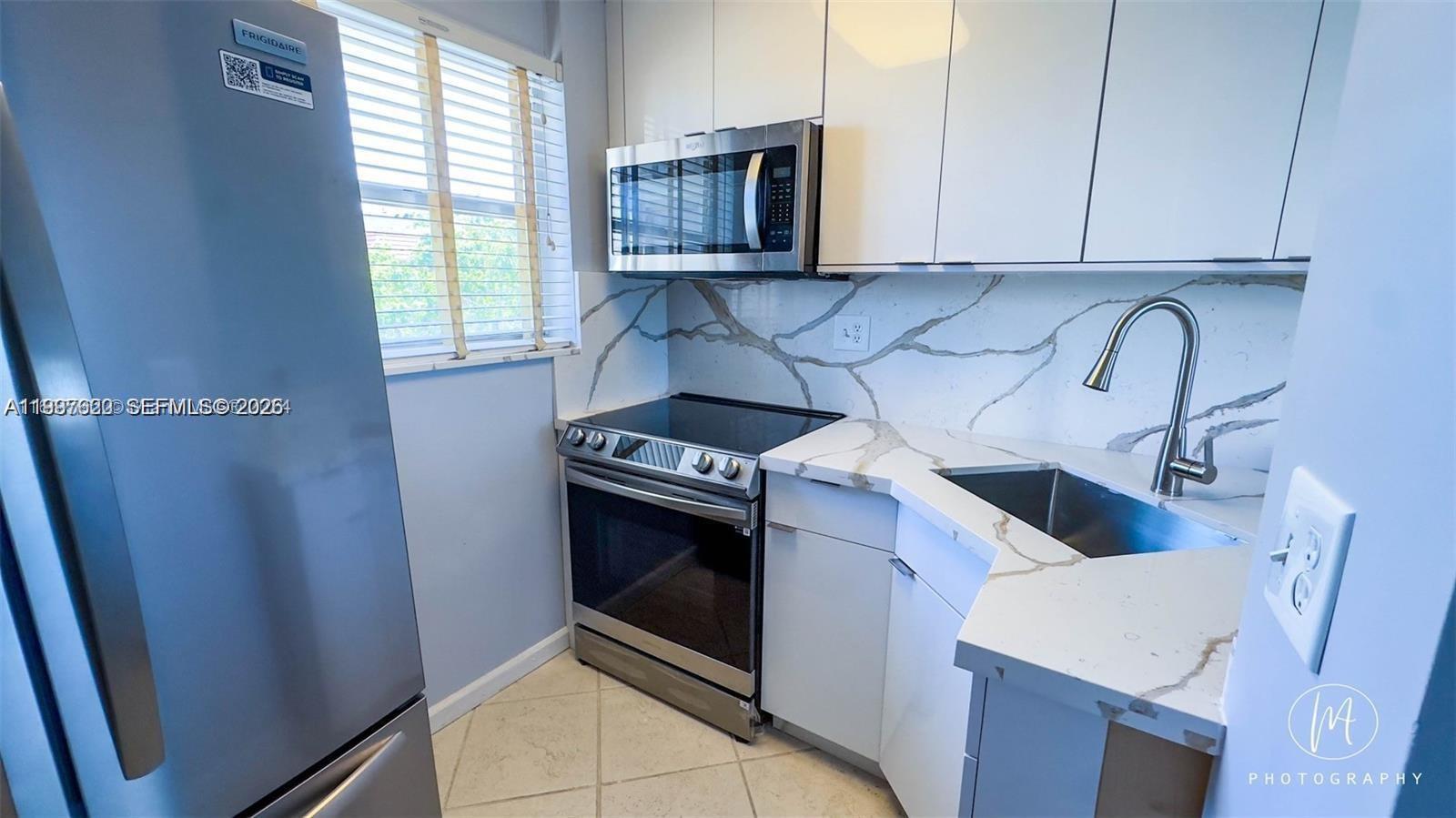 Boater's Dream! This waterfront condo includes your own assigned dock that accommodates up to a 35' x 11' boat—a rare and valuable feature with direct ocean access and no fixed bridges! Enjoy the luxury of stepping from your home onto your boat and cruising the Intracoastal Waterway within minutes—no need for hauling or boat lifts. This bright corner unit features updated kitchen has white cabinetry, quartz countertops, and newer appliances. The bathrooms have also been beautifully renovated. Enjoy picturesque canal views and a lifestyle that’s truly hard to match. Just minutes from the beach, airport, dining, shopping, and walking distance to 15th Street Fisheries and other restaurants. This is a rare opportunity with an assigned dock. Service pets allowed Can rent multiple times per year
