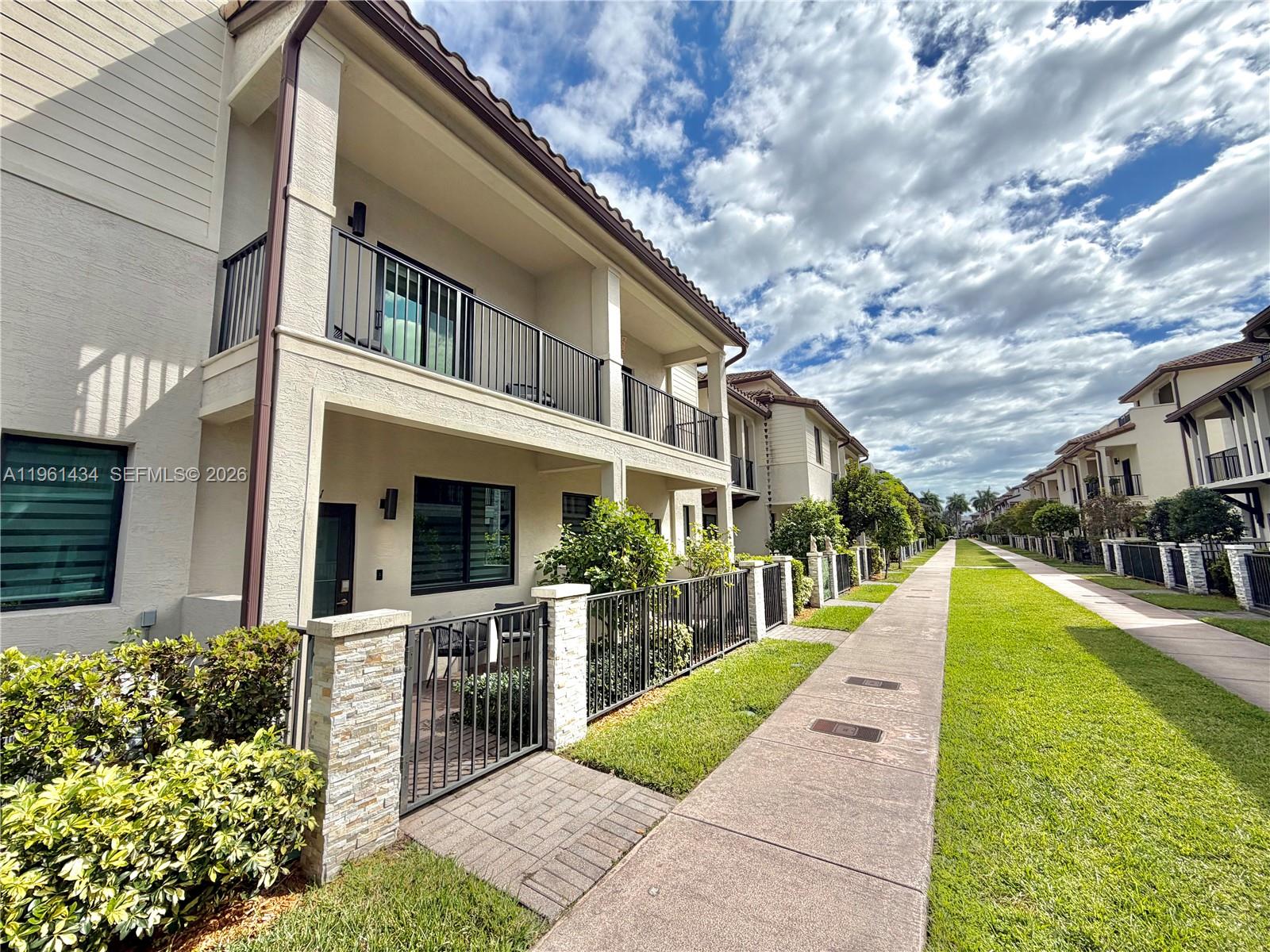 Property for Rent - Downtown Doral. Beautiful three-story residence offering 2,026 sqft of living space with 3 bedrooms, 2 full bathrooms, and 2 half bathrooms. Features include a two-car garage, impact windows, and double terrace with outdoor kitchen, ideal for entertaining. Spacious and modern family room on the third floor. No carpet throughout the home; NEW laminated flooring in bedrooms and stairs. Residents enjoy a modern and spacious clubhouse with full amenities for family entertainment and recreation. Prime location in the heart of Downtown Doral, within walking distance to restaurants, shops, and more. Easy to show, please make your appointment 24 Hrs in advance.