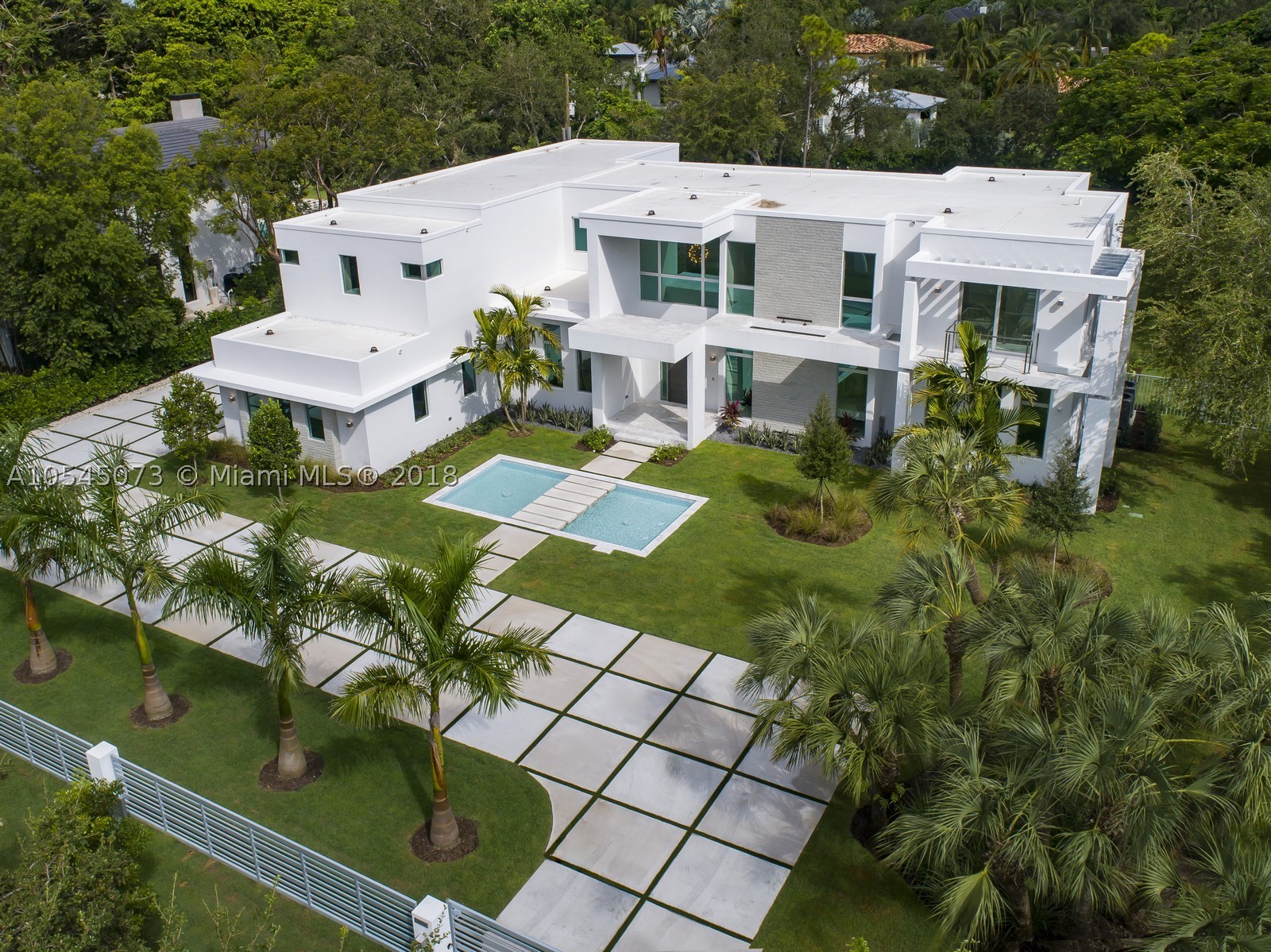 Elegant 2018 Brand-New Modern Estate, Appointed with The Finest Finishes. Approach Your Front Door by Walking Over the Soothing Water Feature. Enter a Spectacular Floor Plan, Full of Amenities, From a Grand & Open Kitchen Featuring Designer Appliances, Living & Dining Rooms, Climate Controlled Wine Cellar, Theater, Grand Master Suite w/Sitting Area, Home Office, Double Water Closets, Massive Closet, To A Stunning Glass Stair Case & Elevator. 36X36 Premier Marble & Wood Floors. Nested on A Deep Lot Allowing Picturistic Views of Backyard from Most Living Areas. Other Features: 2 Laundry Rooms, Smart Integration, LED Lights, Resort Style Pool, Large Impact Glazing, Concrete Roof, Large Covered Summer Kitchen, 3 Car Garage, Fully Gated, Located in Very Quiet Street. Premier Pinecrest Schools.