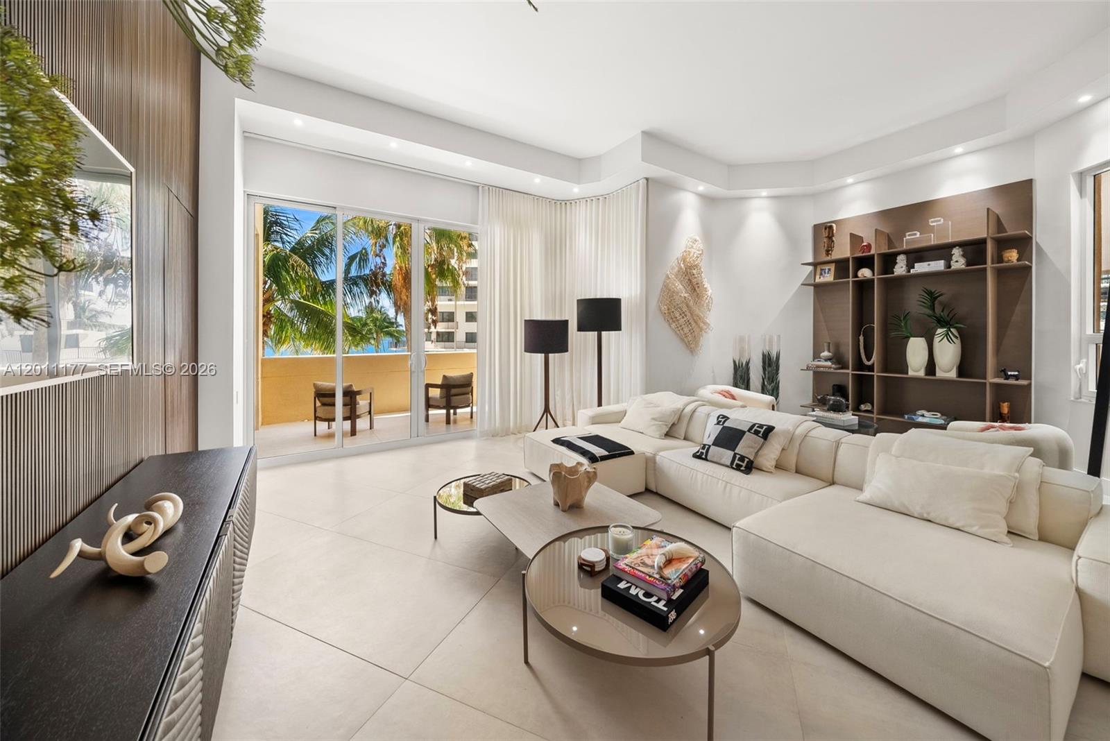 Experience exceptional island living in this impeccably renovated waterfront residence on exclusive, gated Brickell Key. Thoughtfully curated & designed by Fine Line Furniture, the home showcases stunning bay views, 2 private terraces, soaring 15-foot ceilings, & high-end finishes throughout. The custom kitchen features imported European cabinetry by Nobilia, marble countertops, & a suite of top-of-the-line Italian appliances, including ILVE & a built-in cappuccino system, along with a refrigerated wine cellar. Living spaces are elevated by bespoke millwork, custom ceiling detailing, & built-in shelving designed by Fine Line Furniture, creating a refined yet functional environment. Select furnishings include pieces by Artefacto & Roche Bobois, complementing the home’s elevated aesthetic. The primary suite offers a true spa-like experience, featuring imported Italian marble including Calacatta Viola & Portoro, custom vanities & mirrors by Mia Cucina, & premium fixtures by Gessi. The space is further enhanced by a chromotherapy soaking tub & a smart TOTO toilet system. A fully built-out closet by Closet Factory provides exceptional storage, complete with custom detailing & integrated lighting. Motorized window treatments by The Shade Store & designer wall coverings by Phillip Jeffries complete the home’s sophisticated finish. A highly sought-after parking space is conveniently located on the same floor, along with a dedicated storage unit.