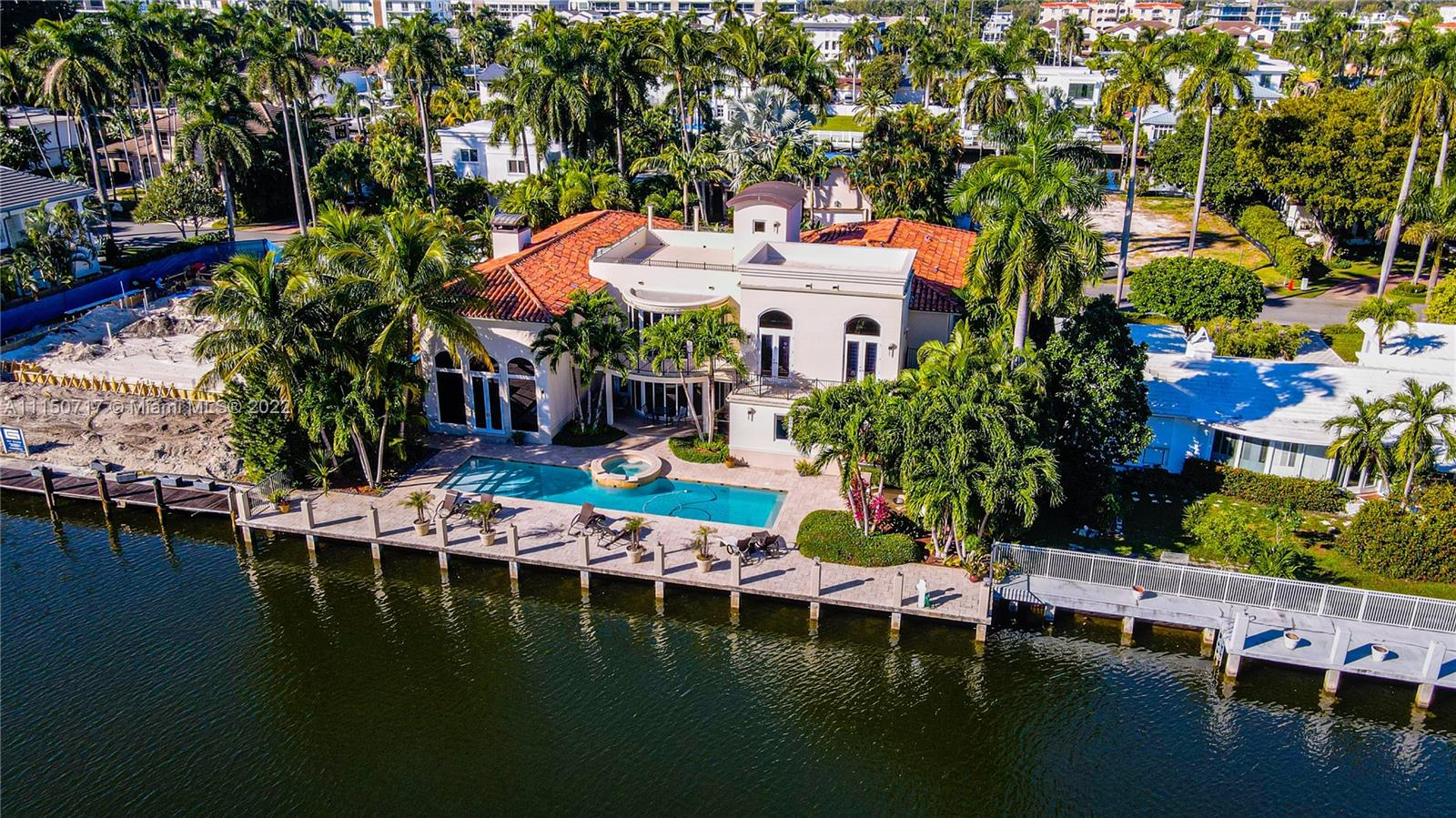 Modern Mediterranean residence with 100 feet of deep water access. Step inside to soaring ceilings, grand staircase, and open spacious floor plan. Ideal for entertaining, this home offers 3 wet bars, an expansive rooftop terrace, and surround sound throughout. The backyard features large pool and spa, summer kitchen, and concrete dock which can accommodate up to 80ft yacht. Inside you'll find a large well-equipped kitchen, elevator, 6 bedrooms, 5.5 baths, and open loft. Oversized master bedroom features wraparound balcony, large walk-in closet, and master bath with dual vanities and jacuzzi tub. Located on the coveted Las Olas Isles, this home is just a few minutes by boat or drive from the best restaurants and entertainment Fort Lauderdale has to offer.