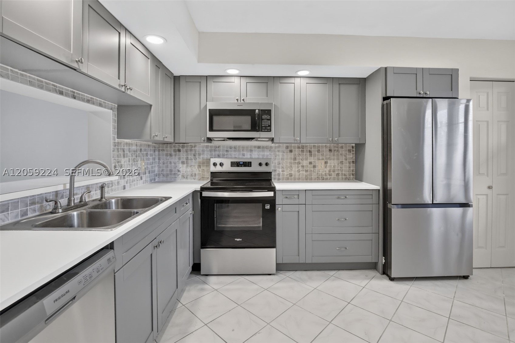 Wow—do not miss this opportunity to live in a beautifully updated 2-bedroom, 2-bathroom third-floor condo, meticulously remodeled with contemporary design upgrades throughout. This stunning unit features soft grey shaker cabinets, elegant countertops with a stone textured backsplash, stainless steel  appliances, and tile flooring throughout the entire home. The pass-through creates an open and inviting layout, allowing you to enjoy seamless views from the dining area straight out to the patio. Step outside and take in a breathtaking panoramic southern exposure overlooking the manicured golf course, lush landscaping, and one of the community’s tranquil ponds. Designed for both comfort and privacy, this unit offers a peaceful, secluded feel while still being ideally located. It is  conveniently located satellite pool.  A stackable washer and dryer are also included for added convenience.