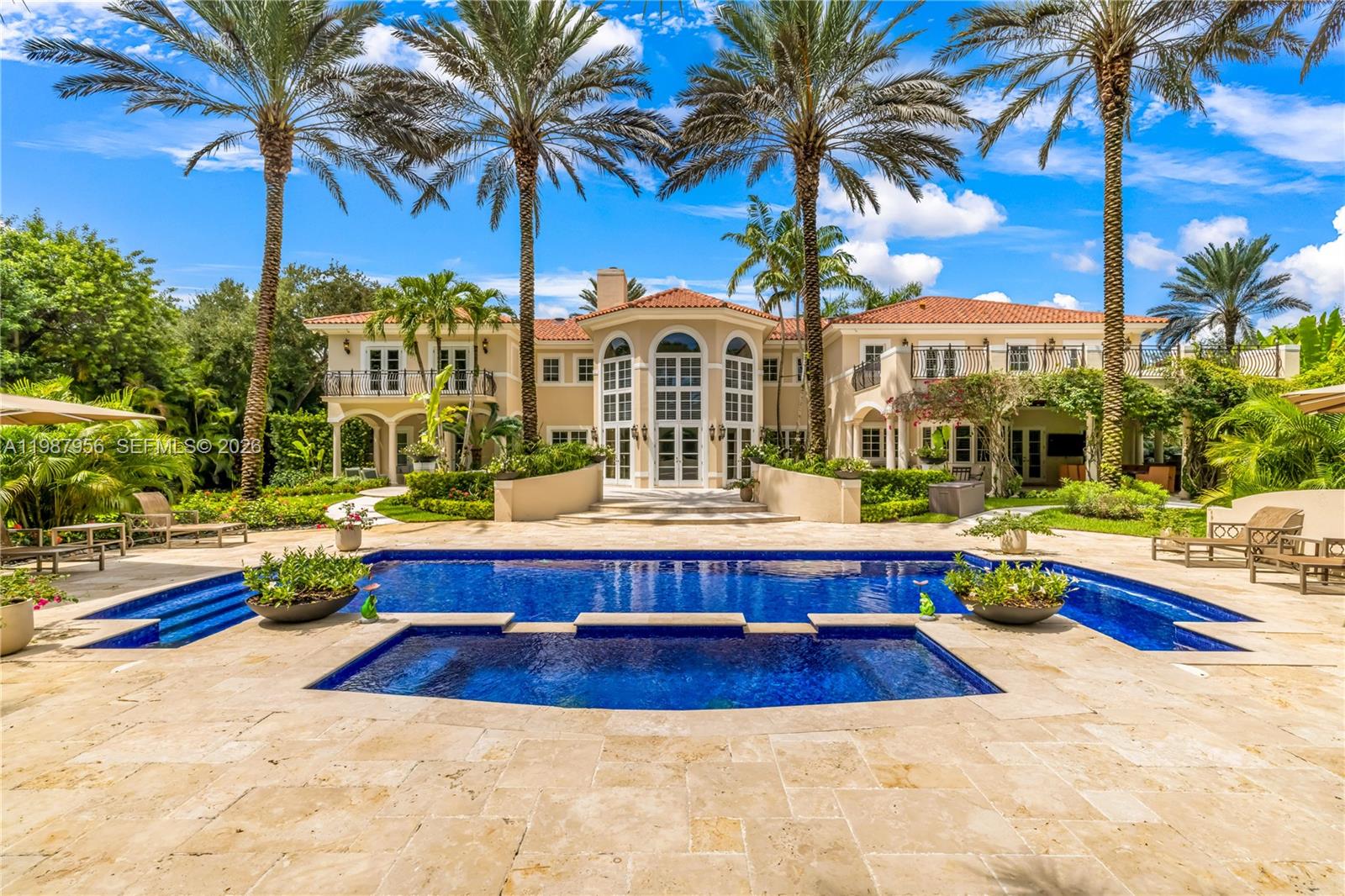 An architectural statement within the prestigious guard-gated enclave of Snapper Creek Lakes, this extraordinary residence blends modern design with refined European influence. Designed by Monaco-based interior designer Milena Sinolovich, the home spans expansive living spaces with marble floors, custom millwork, and curated finishes throughout. The thoughtfully designed layout features 8 bedrooms; 2 downstairs and 6 upstairs, each with en-suite baths. A large private primary suite with dual spa-inspired bathrooms, Jacuzzi tub, and bespoke details. Entertain with ease in the formal living and dining rooms, a custom wine cellar and bar, theater room, and a chef’s kitchen equipped with Miele, Wolf, and Sub-Zero appliances. Outdoors, a heated swimming pool, summer kitchen, and lush landscaping with 28 palm trees create a private resort setting. Complete with elevator, smart home technology, impact glass, generator, and 3-car garage, this is a rare offering of scale, design, and sophistication.