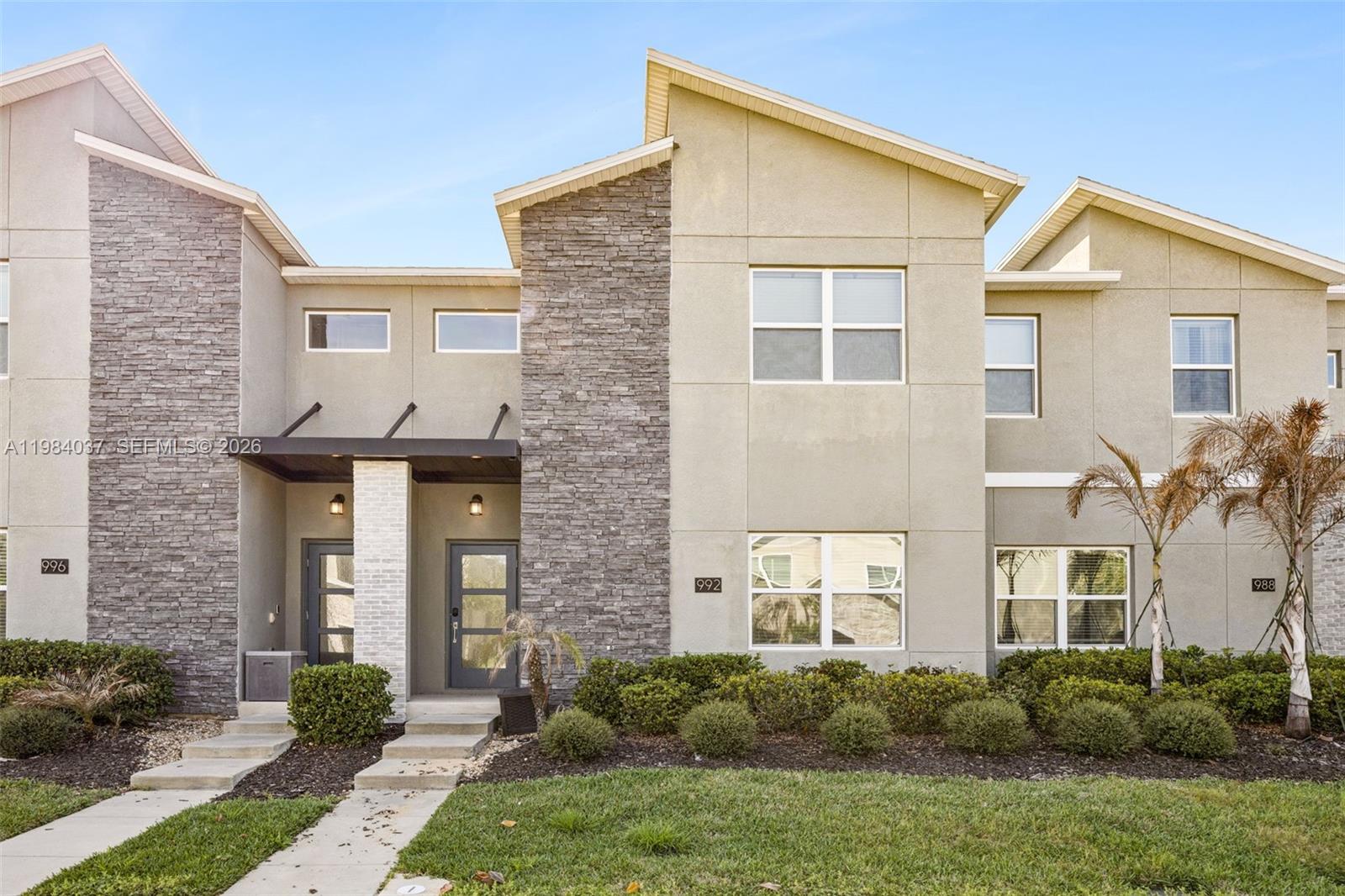 Located in the sought-after Champions Gate community just minutes from Walt Disney World, this fully furnished 4-bedroom, 3-bathroom townhome is the perfect investment, vacation home or primary residence. Approved for short- and long-term rentals, it generated approximately $40,000 in gross rental income in 2025 while still allowing owners personal use. Being sold furnished & turnkey, it’s ready to produce income from day one. The home features an open-concept layout with a modern kitchen, spacious living and dining areas, and a first-floor bedroom with en-suite bath. Upstairs offers a primary suite with walk-in closet, plus two additional bedrooms. Enjoy your private heated pool in a screened lanai. Community amenities include clubhouses, restaurant, tiki bar, lazy river, water slides, fitness center, sports courts, and a premier golf course. HOA covers cable, internet, security, lawn care, and trash. Plenty of open parking.
