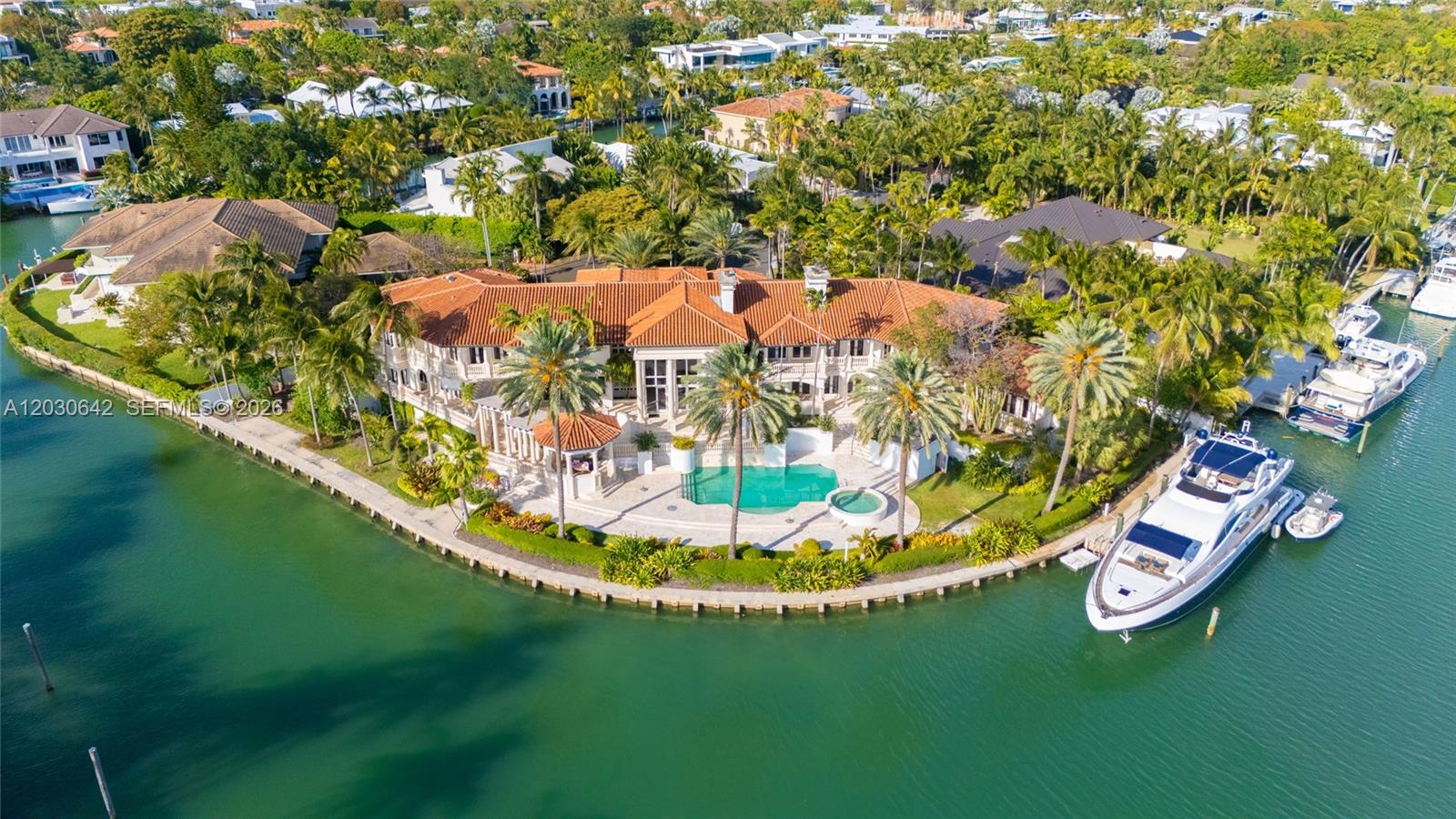 Experience the pinnacle of coastal living in this private, gated waterfront estate situated on one of Miami's most exclusive islands. Offering an unprecedented 346 feet of pristine water frontage and direct ocean access with no fixed bridges, this property is a true paradise for the avid yacht enthusiast. Sprawling across a lush, manicured 32,300-square-foot lot, this compound stands as one of the island's largest and most magnificent properties, perfectly designed for grand-scale entertaining and ultimate privacy. Boasting an impressive 16,076 total square feet of meticulously designed living space, the main residence showcases flawless craftsmanship, striking architectural details, and breathtaking panoramic views of Biscayne Bay and the Pines Canal. Inside, the expansive floor plan features
