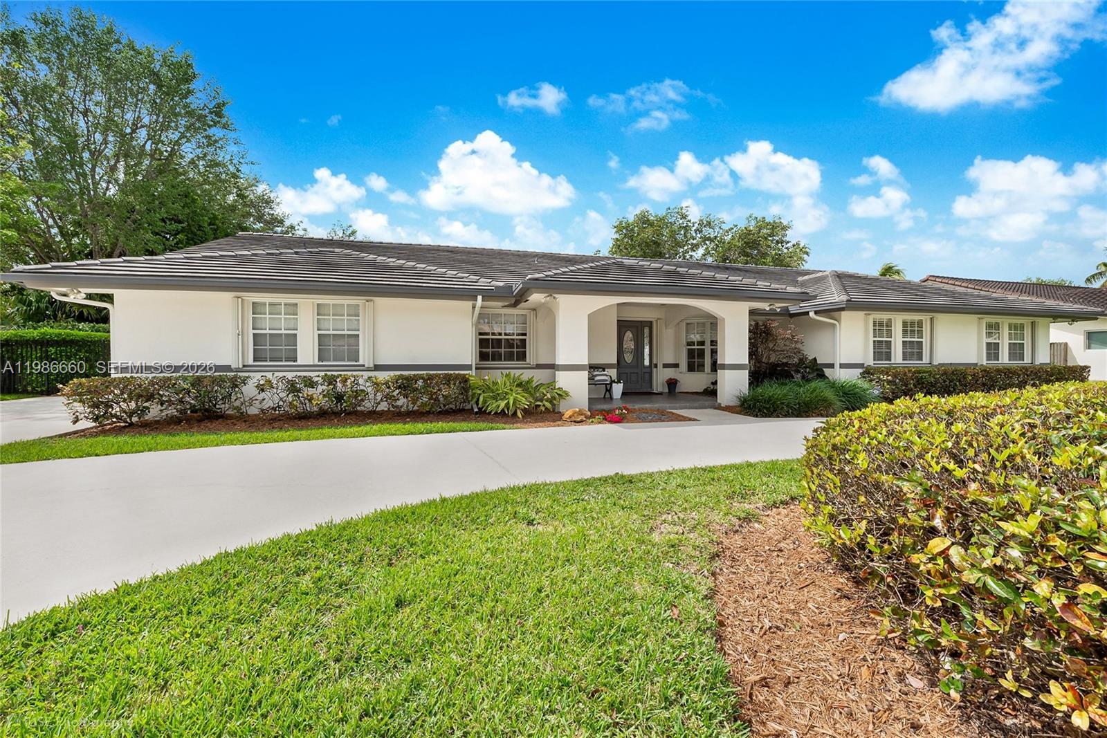Fabulous 5-bedroom 4 bath pool home on a quiet Cul-de-Sac! Formal living room and formal dining room. Big, bright, beautifully renovated eat-in kitchen with a center island and lots of pantry space, opens to a large family room with handsome built-ins. Both rooms look out to a lushly landscaped and inviting pool, patio and yard. Split bedroom plan with the primary and 3 bedrooms on one side, 5th bedroom and bath on the other side, perfect for guest room or office. Luxurious primary suite has vaulted ceiling and his and hers walk-in closets. Pretty, updated primary bath has dual sinks with separate bath and walk-in shower. All bedrooms are oversized. French doors throughout, plantation shutters, 2 AC's, (1 AC 2026), tile roof 2022, security system with cameras, sprinkler system is on a well, water softener, cabana bath and 2 car garage have impact doors, and there is a full set of accordion hurricane shutters. Located in a picturesque neighborhood within walking distance from highly rated Leewood Elementary. A wonderful home!