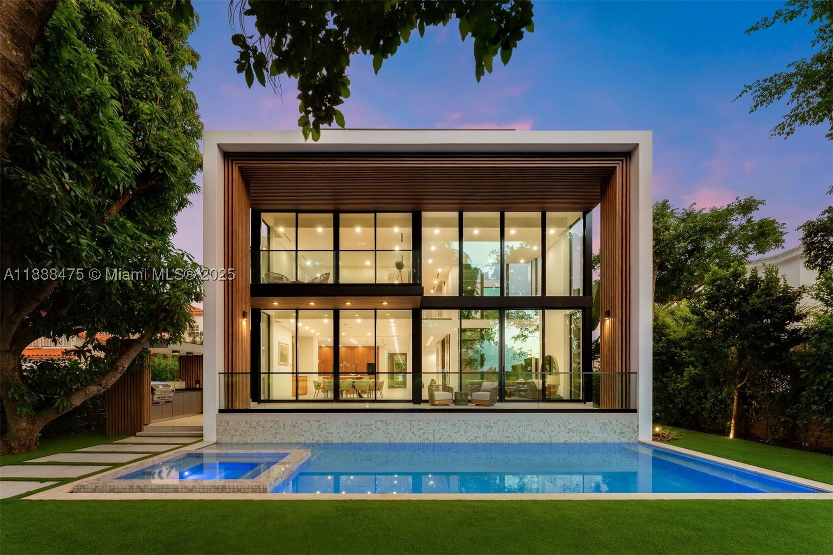 Situated on the Miami Beach Golf Course, this brand-new home is truly one of a kind. The open layout features floor-to-ceiling windows, dual living spaces, a dining area, a wet bar, and an atrium feature that maximizes green space within the home. The formal living area overlooking the backyard showcases a double-height ceiling. The custom MiaCucina kitchen features double BlueStar ovens, dual dishwashers, a Monogram wine fridge, two kitchen islands, and two sinks. Just behind the kitchen, a large, dedicated pantry and laundry room includes a utility sink along with washer and dryer. The first-floor bedroom, currently used as an office, features an en-suite bath. Upstairs, the primary suite includes custom walk-in closets, a private balcony overlooking the golf course, and a spa-style bath with dual vanities, a tub, and a shower. Three additional bedrooms are generously sized, each with en-suite bathrooms and walk-in closets. A rooftop green space provides the perfect setting to enjoy sunset, downtown and Collins Ave views. Outside, a summer kitchen, pool, hot tub, and cabana bath overlook the fairways. The 500 SF garage and wide driveway offer ample parking and storage, with a ramp for added accessibility. Move-in ready and walking distance to 41st Street shops and the best of Miami Beach!
