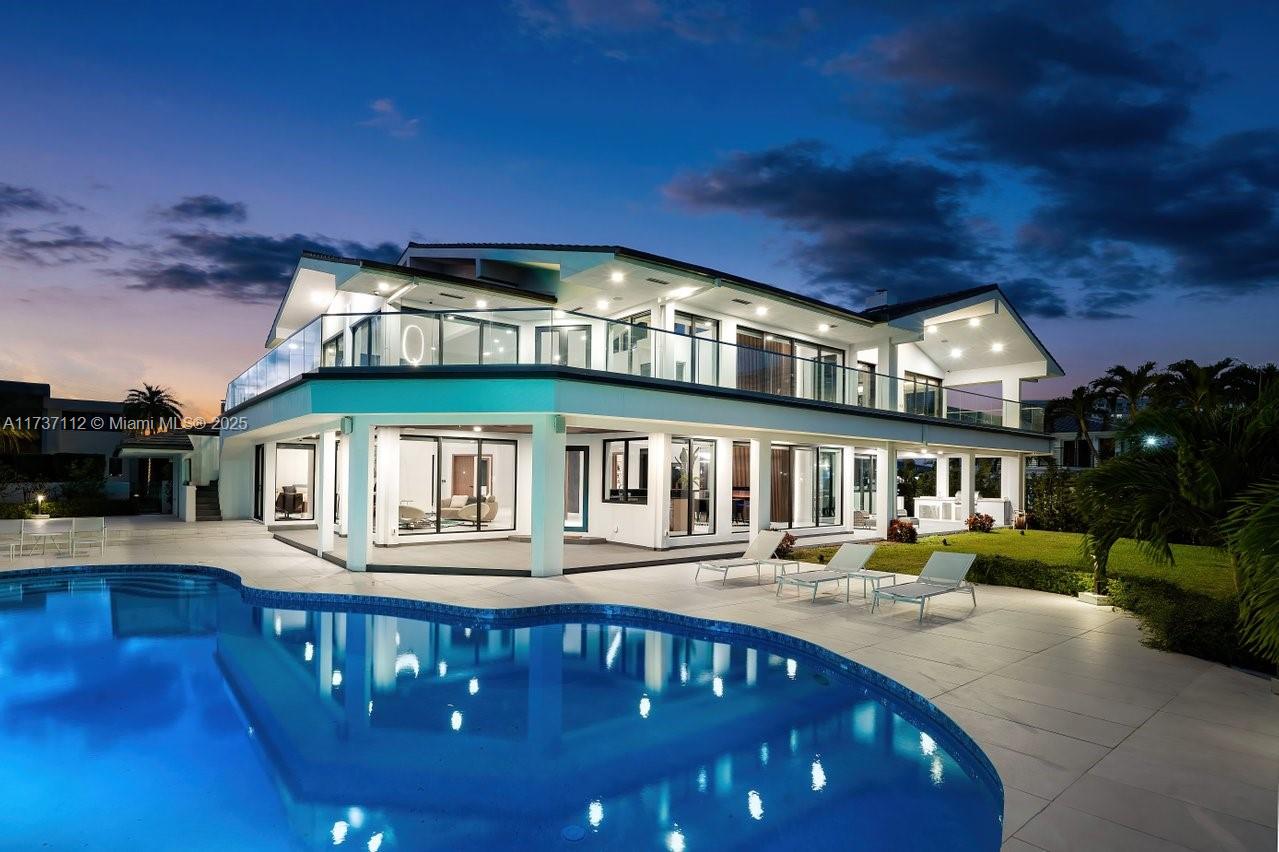 Unveil a new standard of luxurious design in this newly renovated 127' waterfront estate, set within a prestigious,
exclusive gated community. With sweeping Intracoastal Waterway views, this 7,193 sq. ft. modern residence redefines elegance, entertainment and exclusivity. Featuring 5 lavish bedrooms, 6.5 spa-inspired baths,
24-ft ceilings, and world-class amenities, including a media room, elevator, and Crestron Smart Home system. The
gourmet kitchen boasts Snaidero cabinetry, Sub-Zero appliances, and a gas stove. Outdoors, indulge in a heated
pool with waterfall, 50-ft boat lift, BBQ grill, and a private 2-car garage with 6 additional parking spaces. Don't
miss this rare opportunity to embrace waterfront luxury at its finest. Call to schedule a private tour today!