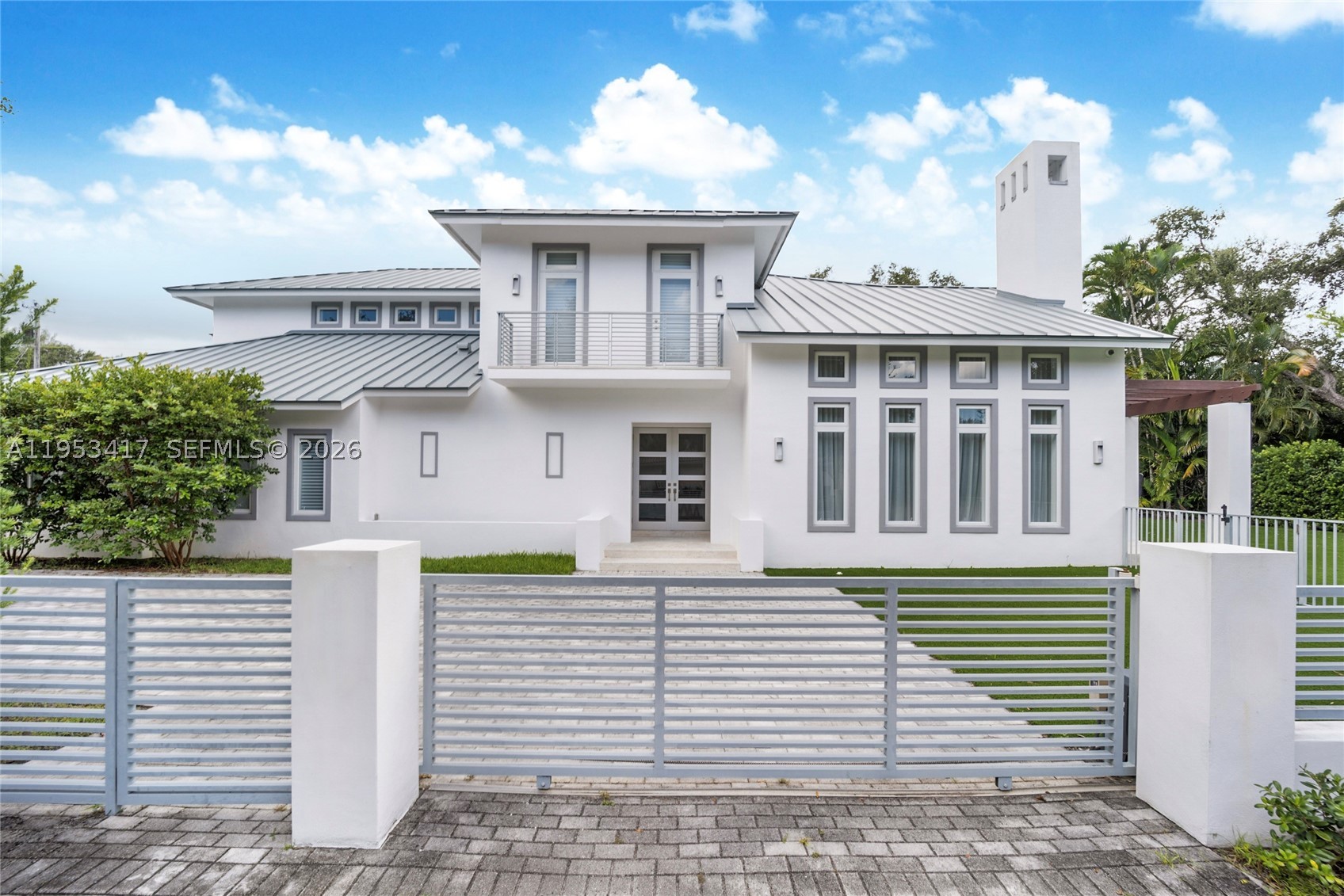 An exceptional executive home perfectly located in South Gables on a fully gated 15,000 sqft lot. Enter the ground floor through a light filled living area with double height ceilings and working fireplace. Large formal dining room leads an eat in kitchen with oversized island and top of the line appliances. Ground floor also features a huge family room and 2 bedrooms both with ensuite baths.  All rooms open to a sparkling tropical pool and large terrace, perfect for entertaining. The 2nd floor boasts an oversized primary suite with spa like bath and walk-in closet, a home office area and 2 bedrooms with ensuite baths and balconies overlooking the pool. This gated home has a 3-car garage with huge driveway and plenty of room for parking.