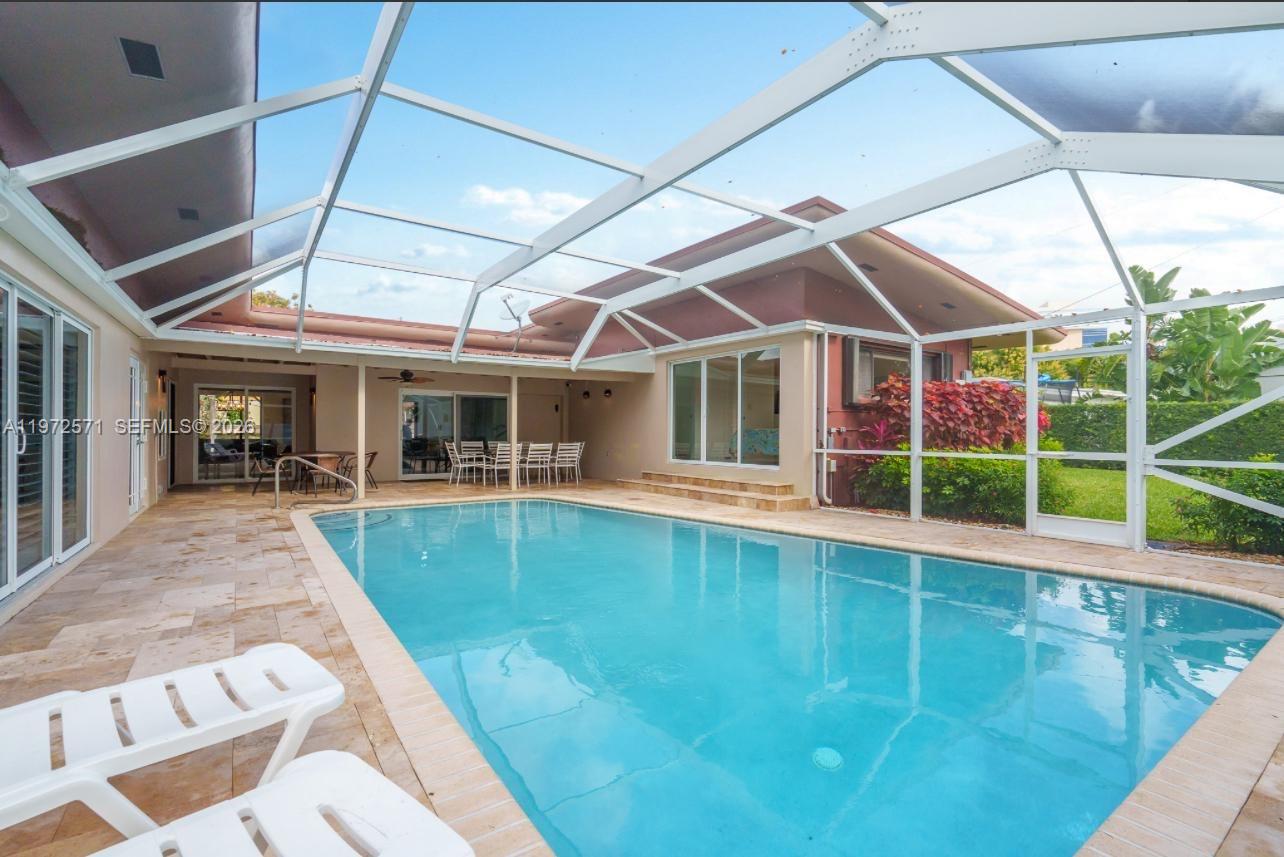 With over 2,000 square feet of living space, this four-bedroom, two-bathroom property presents a strong investment opportunity. The home is currently tenant-occupied, generating $5,000 per month in rental income. Features include a heated, screened-in pool, this home is renovated and updated in key areas, a paved circular driveway accommodating multiple vehicles, and four covered carport spaces. Located in Hollywood Hills with convenient access to I-95, shopping, and dining, the property offers both stable income potential and long-term appreciation in a high-demand area.