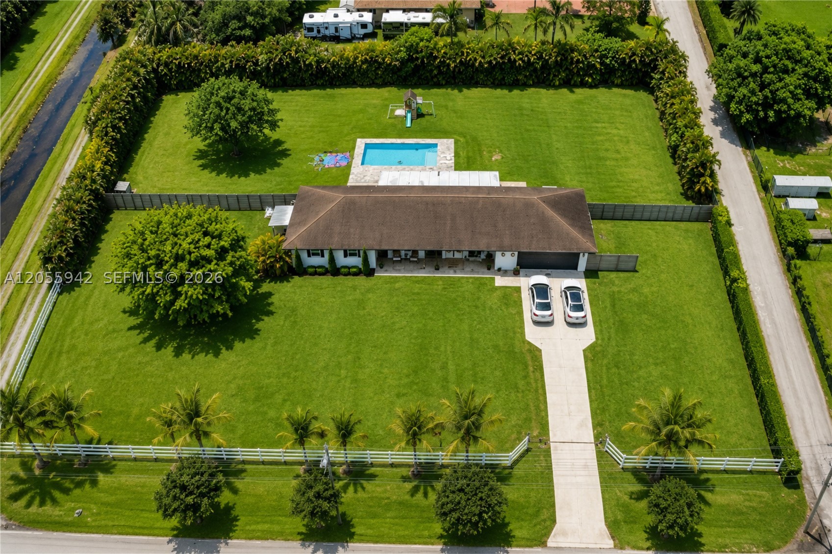 Exceptional Estate on Nearly 2 Acres in Rolling Oaks, Southwest Ranches. Discover the perfect blend of luxury, privacy, and space in this beautifully renovated estate located in the prestigious Rolling Oaks community of Southwest Ranches. Situated on an impressive 86,337-square-foot lot, this sprawling property is surrounded by beautifully landscaped grounds, offering the ideal country-suburban lifestyle. Designed with an open-concept floor plan, the home features expansive living areas, elegant marble flooring throughout, and a beautifully updated kitchen that serves as the heart of the home. Hurricane impact windows and doors provide both peace of mind and abundant natural light. Step outside to an expansive screened patio complete with a built-in summer kitchen, overlooking an oversized pool—the perfect setting for entertaining or enjoying South Florida's year-round sunshine. A standout feature of this home is the private in-law suite, complete with its own bathroom, kitchenette, and wet bar, making it ideal for multigenerational living, extended guests, or a private home office. With nearly two acres of land, there is plenty of room to expand, create additional outdoor amenities, or simply enjoy the privacy and open space that make Southwest Ranches so desirable. The sellers have plans for an expansion that can be shared. This is an opportunity to own an exceptional property in one of South Florida's most sought-after communities. Schedule your private showing today!