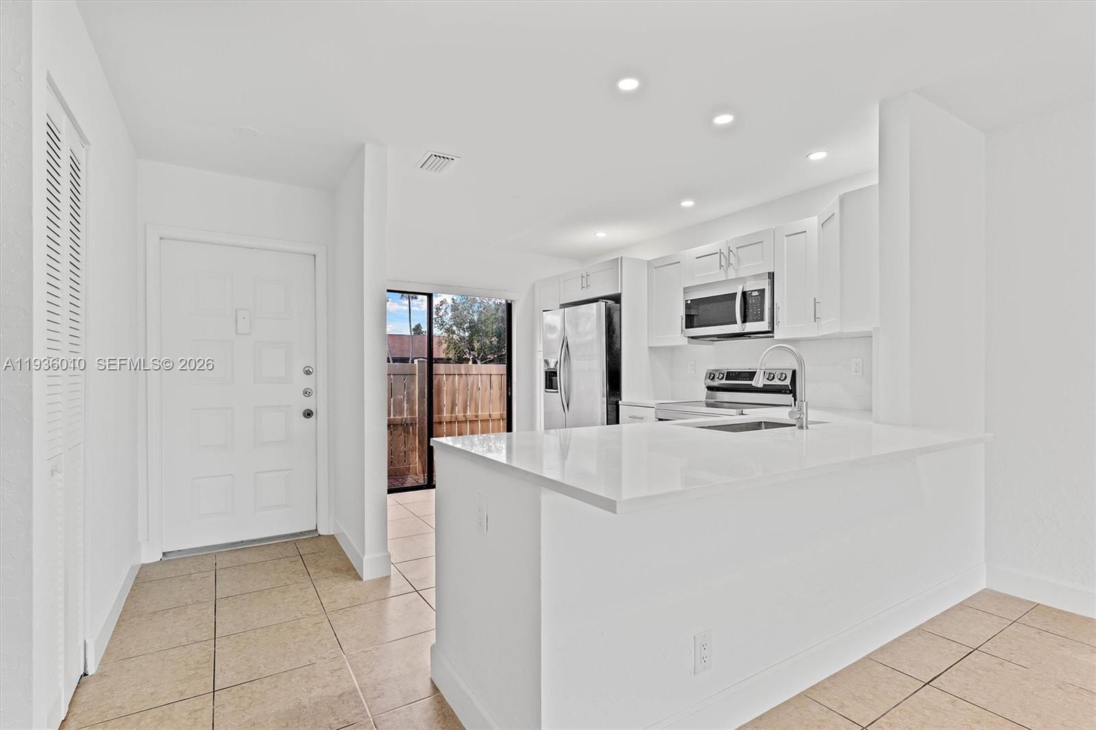 Move-in ready 2BR/2BA villa in desirable Woodlake Isles. Updated home features a brand new roof fully paid for by the seller with NO special assessments, plus a new water heater and open-concept kitchen with full quartz backsplash. Tile floors throughout, fresh paint, new baseboards, bright living/dining area, walk-in closet, and first-floor entry. Enjoy a private fenced patio perfect for outdoor relaxation. Community amenities include heated pool, tennis courts, and clubhouse. HOA covers exterior maintenance, roof, landscaping, insurance, and pool. Pet-friendly with approval. Centrally located near shopping, dining, and major roads. Vacant and easy to show.