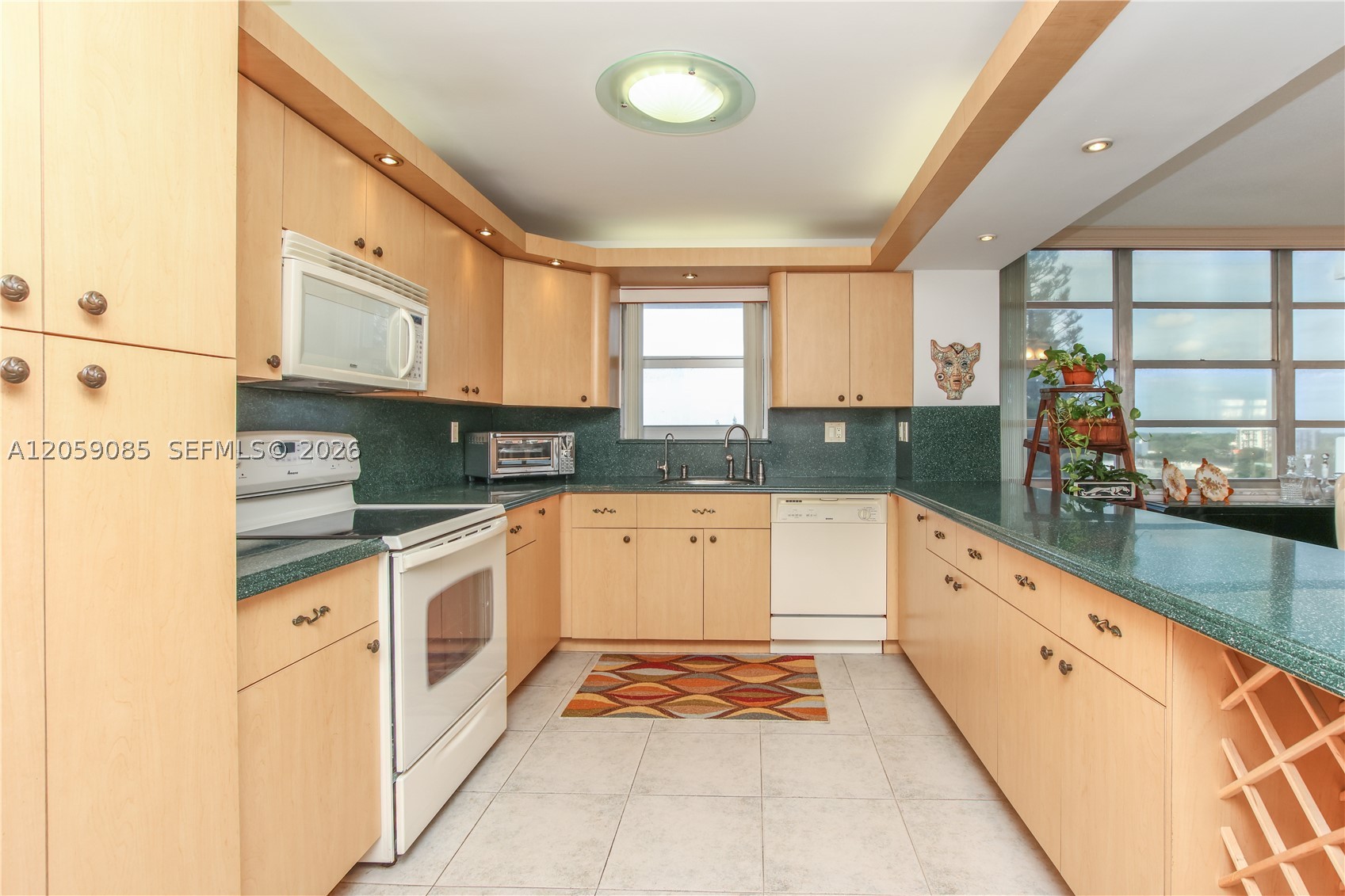 LOCATION, LOCATION, LOCATION! Step into this beautiful corner unit — the largest floor plan in the community — and enjoy stunning sunset views from your private balcony. This bright and spacious home offers an open kitchen, stainless steel appliances, and elegant ceramic tile floors throughout the living areas. The community boasts unmatched walkability with Fresh Market, restaurants, banks, and shops just steps away. Enjoy resort-style amenities including 2 tennis courts, marina, gym, billiards, ping pong, car wash area, picnic/BBQ areas, 2 heated pools, gazebo, library, and more.