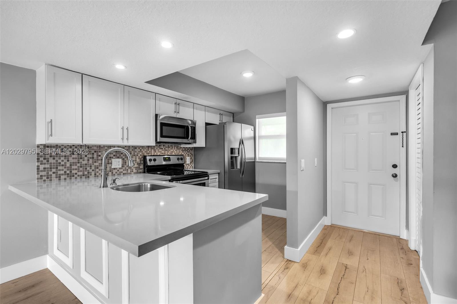 Welcome to Sunwood in the desirable Ludlam area, just minutes from Coral Gables. This well-maintained second-floor split-level condo features impact windows throughout, electric shades, an updated kitchen and bathrooms, vinyl flooring, and fresh interior paint. Enjoy the convenience of a full-size washer and dryer, IKEA closet system, and an A/C system replaced in 2020/2021. Extra matching vinyl flooring is included for buyers who wish to replace the staircase carpet. Located in a family-friendly neighborhood close to shopping, dining, schools, and major roadways, this home offers both comfort and convenience in a prime location.