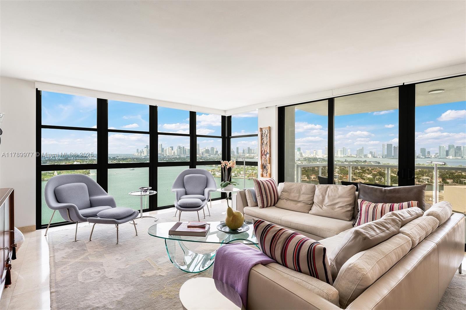 Welcome to 9 Island, where luxury meets location. This rare 01 line on the 21st floor offers stunning views of the Miami skyline and Biscayne Bay with unforgettable sunsets. The renovated 2BD/2.5BA unit features modern finishes and a spacious layout. Enjoy top-tier amenities: a state-of-the-art gym, children's playroom, private marina, tennis court, and Bay Room for entertaining. Located in the heart of the Venetian Islands, you're just steps from Sunset Harbor's shops, markets, restaurants, playground, and dog park. Experience Belle Isle living with the convenience of the city. Impeccably maintained building with outstanding