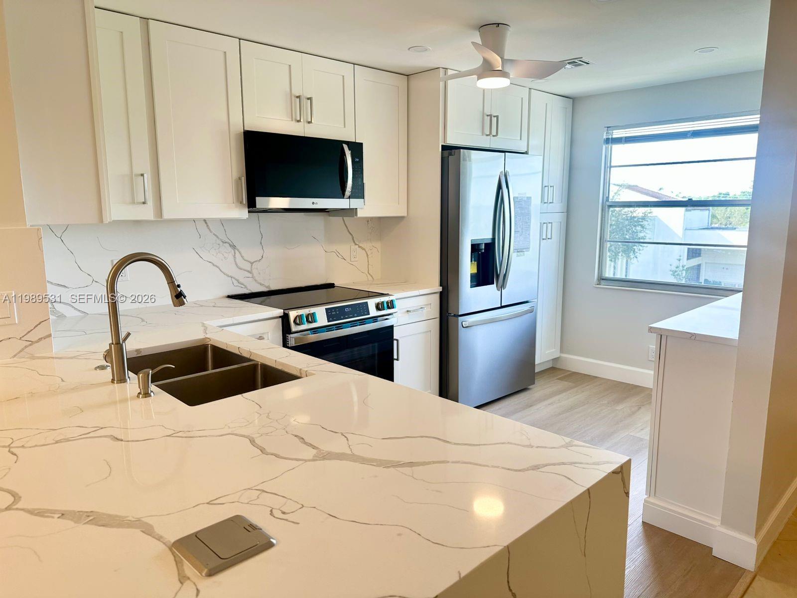 Beautifully Renovated Corner Unit, Top floor, no one above you. Century Village Boca West - Surrounded by water views.  Brand new kitchen with waterfall Quartz, new cabinets, and new appliances - New luxury vinyl flooring in bedrooms - New porcelain floor and vanities in bathrooms - New tile in enclosed balcony and hurricane shutters.  Closest building to the clubhouse and houses of worship, 2 minute walk.