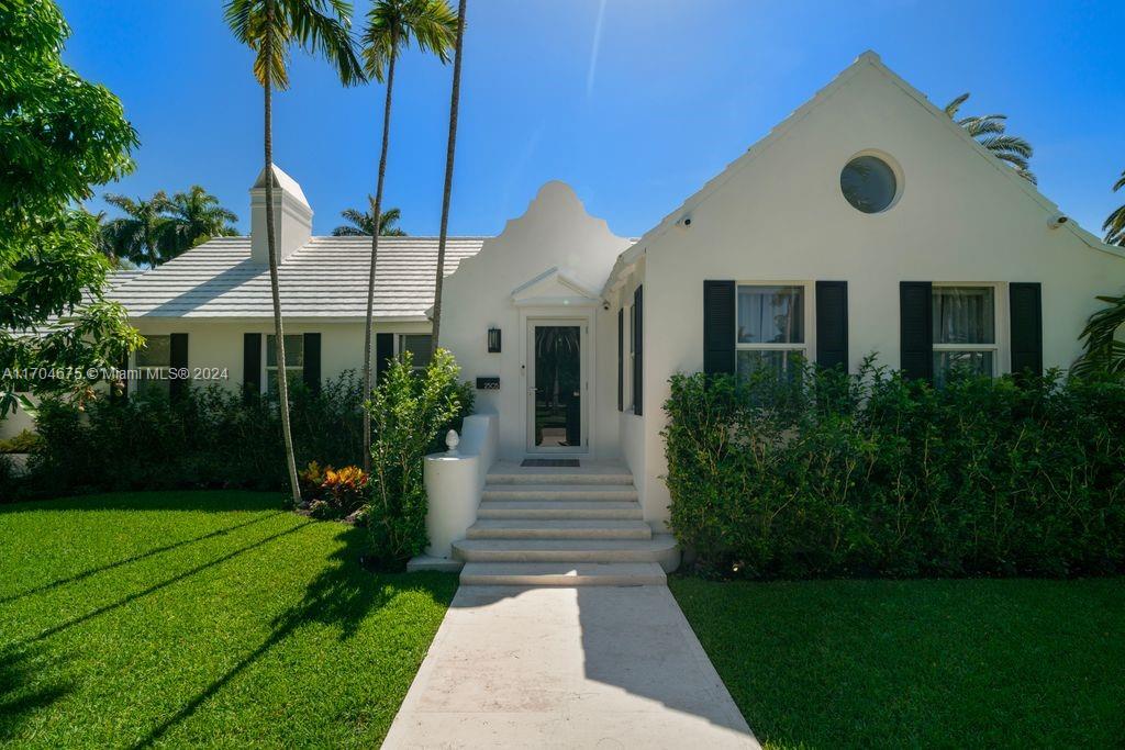 Experience coastal luxury in this fully renovated 4BR/4.5BA home on Sunset Island II. Nestled on a coveted corner lot directly across from a tranquil, palm-lined park, this turnkey residence welcomes you w/ soaring ceilings & sweeping views of the lush backyard, complete w/ an oversized sparkling pool. Natural light floods the home through hurricane-impact glass walls & doors, highlighting the spacious great room w/ a marble-clad fireplace & exposed wood beams that flow through the open floorplan. The custom-designed eat-in kitchen feature marble countertops & high-end Miele and Subzero appliances. The serene primary suite offering a spa-inspired bathroom w/ a large walk-in closet, dual-headed shower, dual sinks, a vanity area & French door that lead to the private pool & backyard paradise
