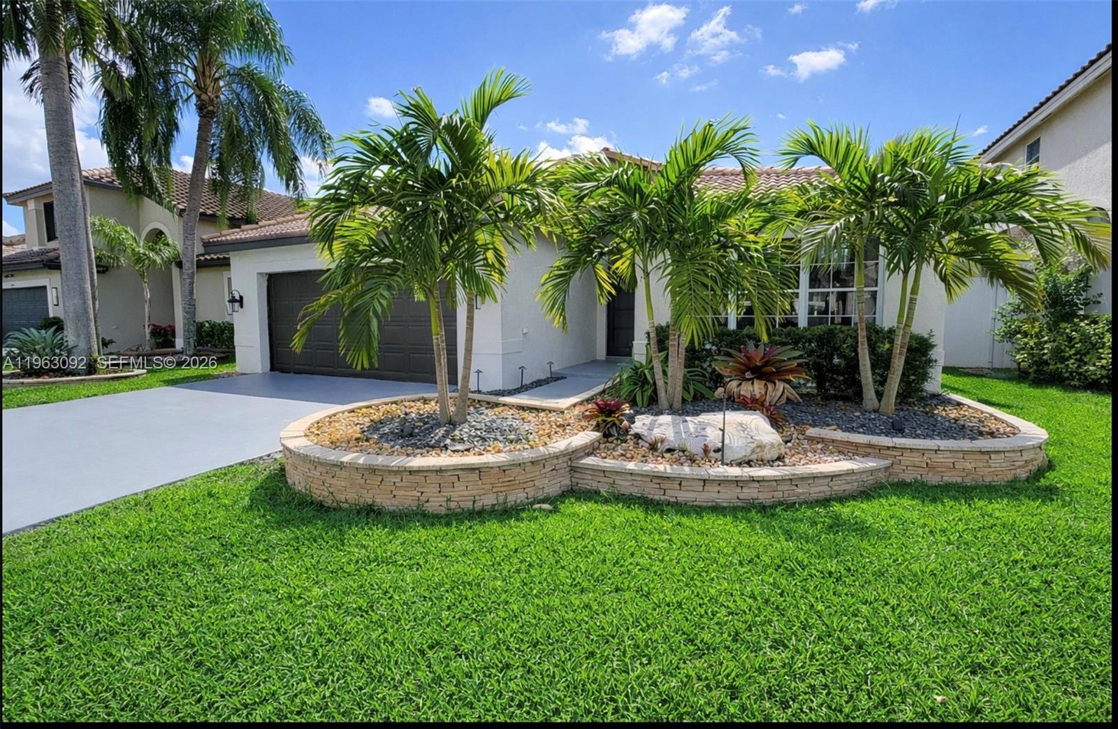 Home is in excellent condition and truly move-in ready. The extra-large kitchen is perfect for hosting family and friends. This home features hurricane-proof front and sliding doors, a screened-in porch with ceiling fans, and an oversized primary suite with a private ensuite bathroom. Both guest bedrooms comfortably fit queen-sized beds and include nicely sized closets. A custom-built family entertainment center sits just off the kitchen, creating the perfect gathering space. Major appliances and systems have been recently updated — the washer, dryer, A/C, and refrigerator are all less than four years old. Enjoy a beautiful entrance with raised landscaping and exterior  lighting, along with a low-maintenance yard. And best of all, the community pool is just a short walk away — practically right around the corner.