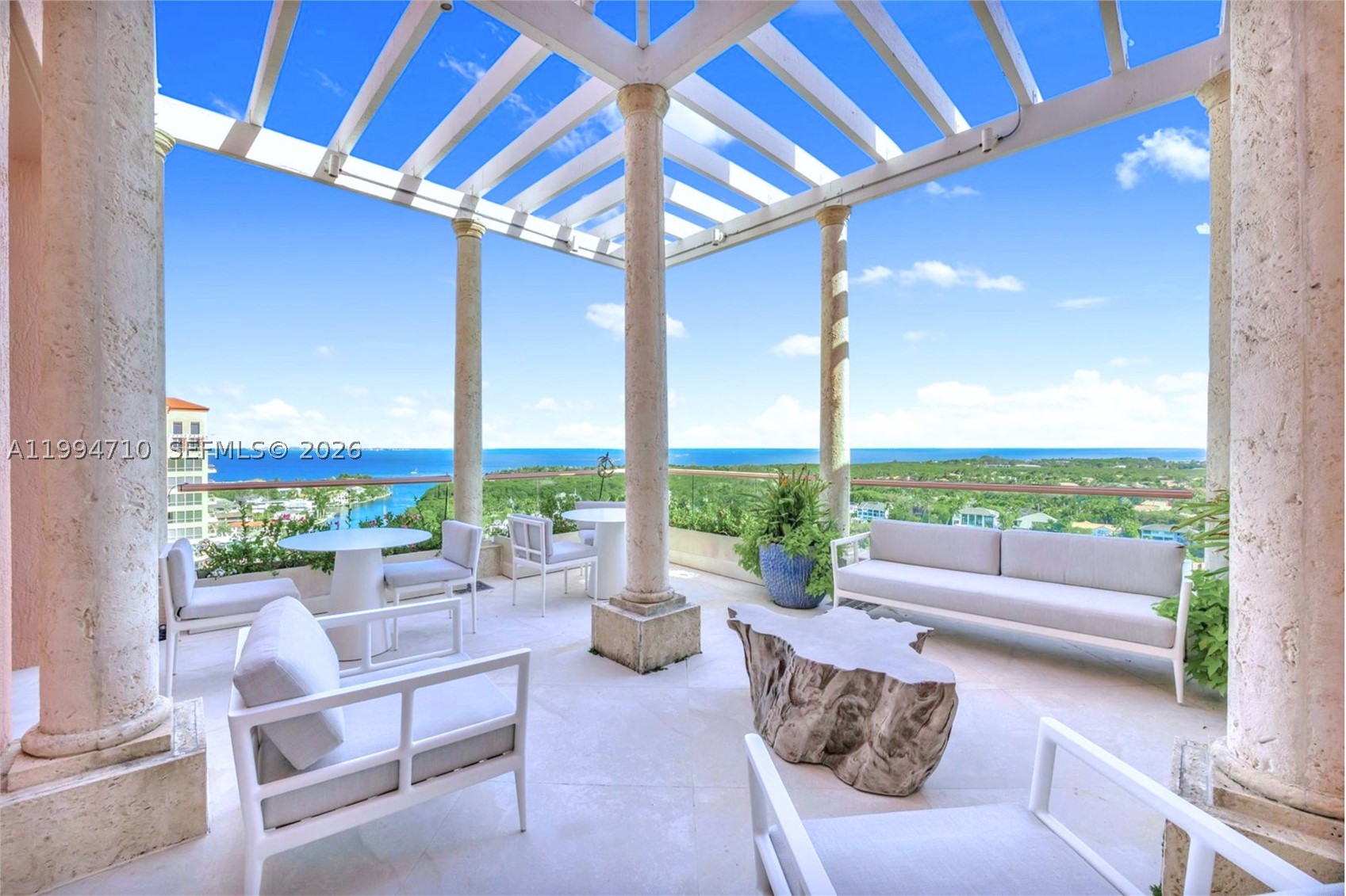 Rare two-story Tower Suite penthouse at The Gables Club offering breathtaking panoramic views of Biscayne Bay & the Miami skyline. Featuring 5 beds, 6.5 baths, & over 10,500 SF of interior space plus 2,600+ SF of expansive terraces, this exceptional residence showcases a private elevator entry, dramatic 30-foot ceilings, formal dining room, gourmet kitchen with butler’s pantry & secondary kitchen, as well as a loft-style entertainment level complete with bars, media room, and two private offices. The primary suite is a private retreat featuring dual bathrooms & oversized walk-in closets, complemented by five additional en-suite bedrooms. Finishes include limestone flooring, Venetian plaster walls, custom built-ins, and striking Chihuly-style ceiling artwork. A Crestron smart home system, surround sound, & impact windows provide modern comfort & security. Multiple terraces, including one with a built-in BBQ, offer seamless indoor-outdoor living. This offering includes three assigned parking spaces, one of which is located in a private air-conditioned garage, additional storage, & an approximately 50-foot boat slip. Residents of The Gables Club enjoy an exclusive, resort-style lifestyle with access to a private marina, multiple swimming pools and spa areas, state-of-the-art fitness centers, lighted clay tennis courts, a waterfront clubhouse with dining & social spaces, 24/7 concierge, valet, & gated security, all within one of Coral Gables’ most prestigious waterfront community.