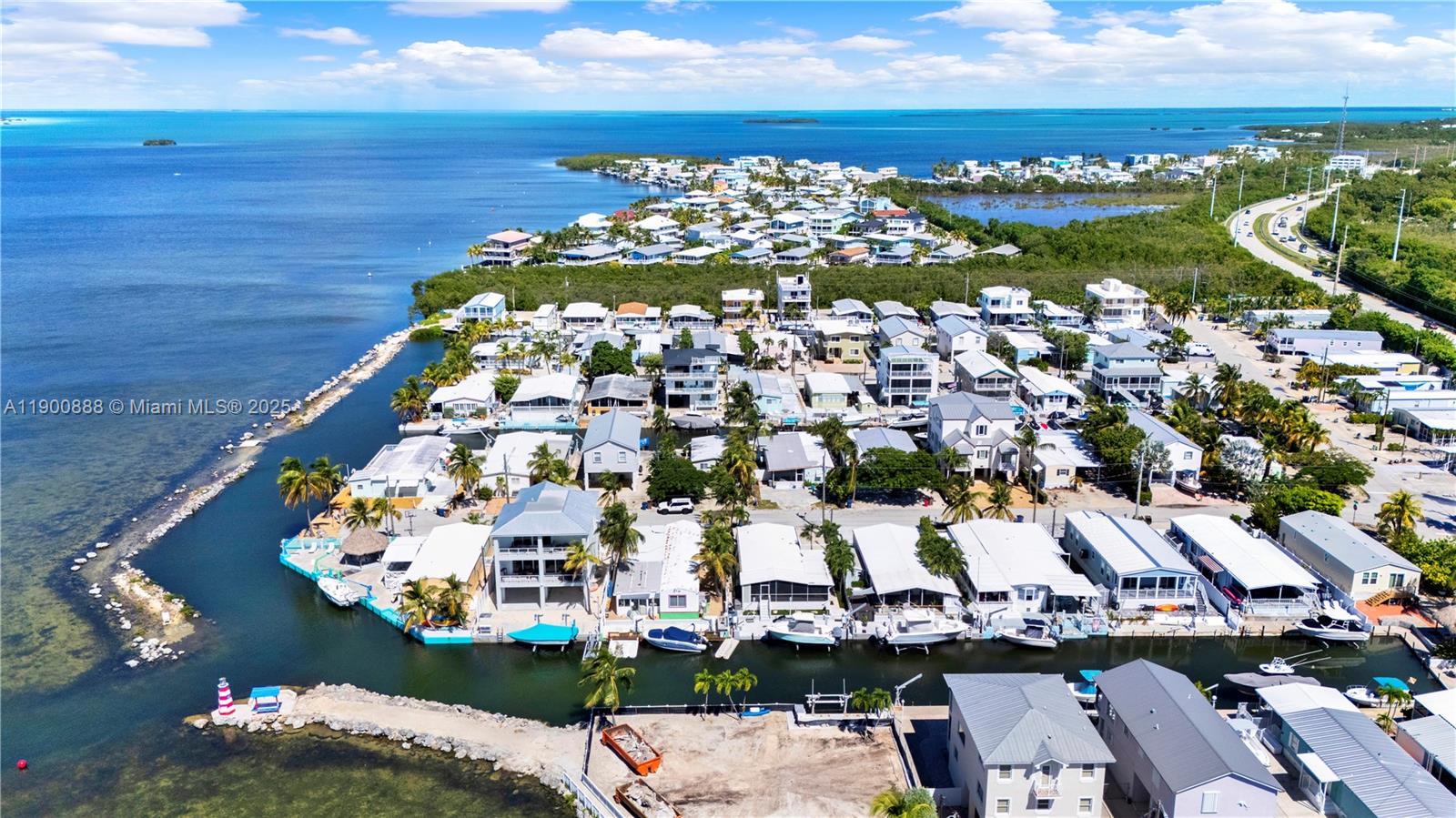 Waterfront Living at Its Best: a move-in-ready home that perfectly combines comfort, style, and coastal charm. The beautifully updated kitchen features stainless steel appliances, quartz countertops, and a modern design that opens to a spacious great room filled with natural light — ideal for entertaining or relaxing while taking in the breathtaking bay views. This property also includes a private studio, perfect for a home office, gym, or guest suite. Step outside to your waterfront oasis, complete with a jacuzzi and private dock offering easy ocean access — perfect for boating, or enjoy the spectacular sunsets. Enjoy the home as-is or take advantage of this incredible location to build your dream waterfront residence. Experience the Florida Keys, where every day feels like a vacation!