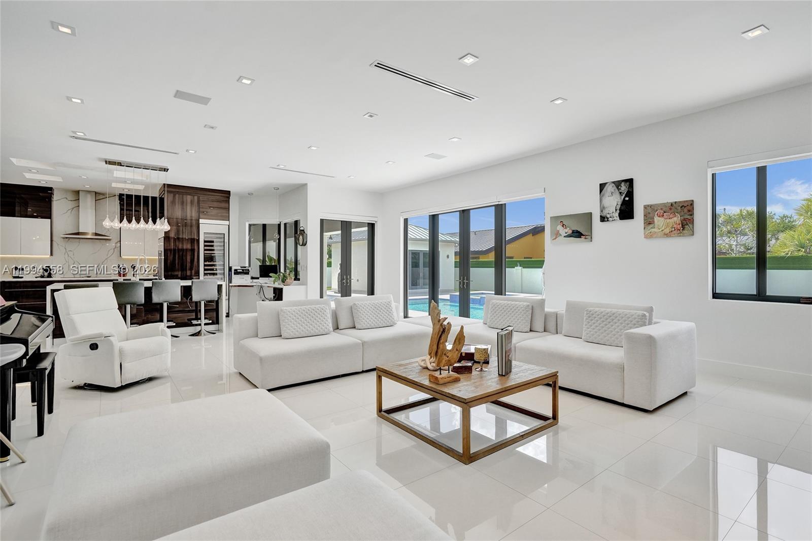 Fully renovated contemporary home combining refined style, timeless design, and high-level engineering. This one-story residence features porcelain flooring throughout, wood floors in bedrooms, generous family and dining rooms, plus a formal living space. Chef’s kitchen with Sub-Zero/Wolf appliances and stone countertops connects to open entertaining areas. Primary suite offers his-and-hers walk-in closets, dual vanities, and oversized shower with dual rainfall heads. Resort-style patio includes marble pool deck, Jacuzzi, covered terraces, summer kitchen, and guest suite. Additional features include new metal roof, impact windows and doors, motorized blinds, circular driveway, and cul-de-sac.