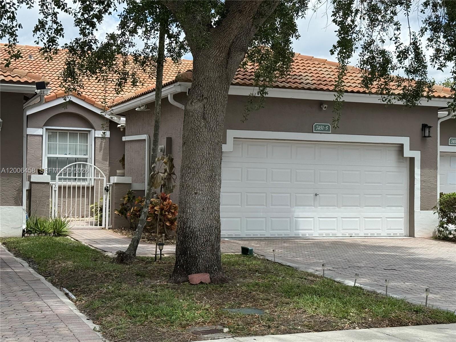 Beautiful Villa with 2 bedrooms, 2 bathrooms & 2 car garage. Remodeled throughout, open floor plan with vaulted ceilings, tiled floors, kitchen with wood cabinets and granite counter tops, stainless steel appliances, large master bedroom with walk-in closet, 2nd bedroom with built-in queen sized murphy bed that can be converted into a desk or it can be removed by Seller, impact doors and windows, accordion shutters, laundry room with full size washer and dryer, beautiful water and garden views from a large screened back patio, two car garage with spacious driveway for additional parking. Gated Community with three entrances, low Association fee that includes Lawn care, ADT security, comcast cable, a Clubhouse, two pools in the community, tennis courts and gym. Great for Owner occuoied or for investment property. New construction nearby that it will bring higher values to this community! Please call for more information or for a private showing!