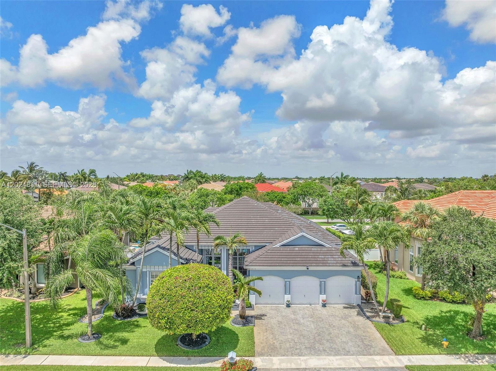 Welcome to your ultimate South Florida oasis! Step inside to a bright, open floor plan loaded with upscale character, featuring tile throughout the main living areas, striking crown molding, and REAL hardwood floors in the spacious bedrooms. The kitchen boasts granite countertops, a custom stone backsplash, and chic pendant lighting over the breakfast bar. Every single bathroom has been completely and luxuriously remodeled from top to bottom, including a breathtaking primary suite retreat. Total peace of mind is built right in with a brand-new roof installed in 2022, accordion hurricane shutters, and a security camera system.

But wait!! The highlight of this property is hosting ultimate weekend gatherings or relaxing in your pristine, heated pool, which features a custom stone waterfall wall and is safely housed under a massive screened-in enclosure. The covered patio is spacious with electric retractable awnings, set against a beautifully landscaped, custom-lit garden with concrete borders and no rear neighbors.

The Estates of Pembroke Shores is a 24-hr guard-gated private community that is conveniently located near I-75, golf, schools, hospitals, parks, restaurants, and shopping. Turnkey perfection awaits!