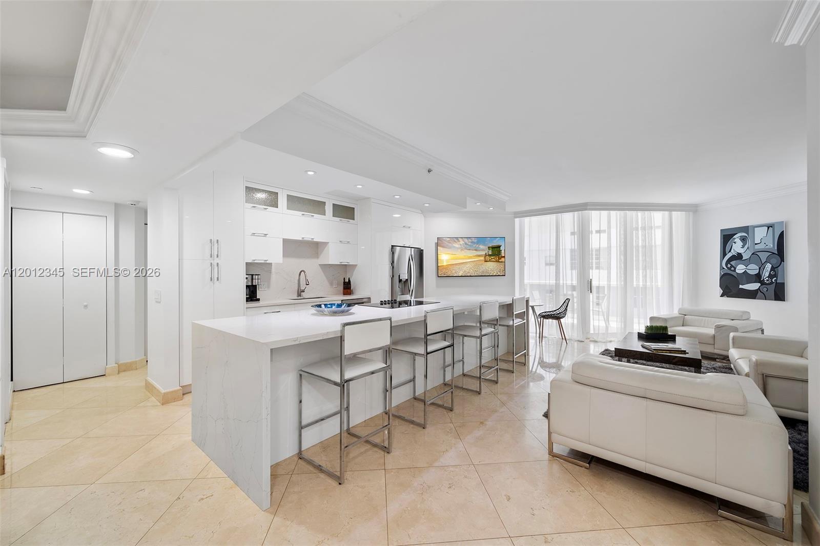 Beautiful 2-bed, 2-bath residence with modern finishes and  offering ocean and bay views. The fully renovated open kitchen flows into spacious living/dining areas. The primary suite features a custom walk-in closet and a separate tub/shower. Both bedrooms open to a large terrace. This unit is in a building with top-tier amenities, including direct beach access, a resort-style pool, fitness center, fitness classes, tennis courts, cafe, and spa. Surrounded by dining, shopping, and entertainment, it perfectly blends comfort and convenience in a highly sought-after location.