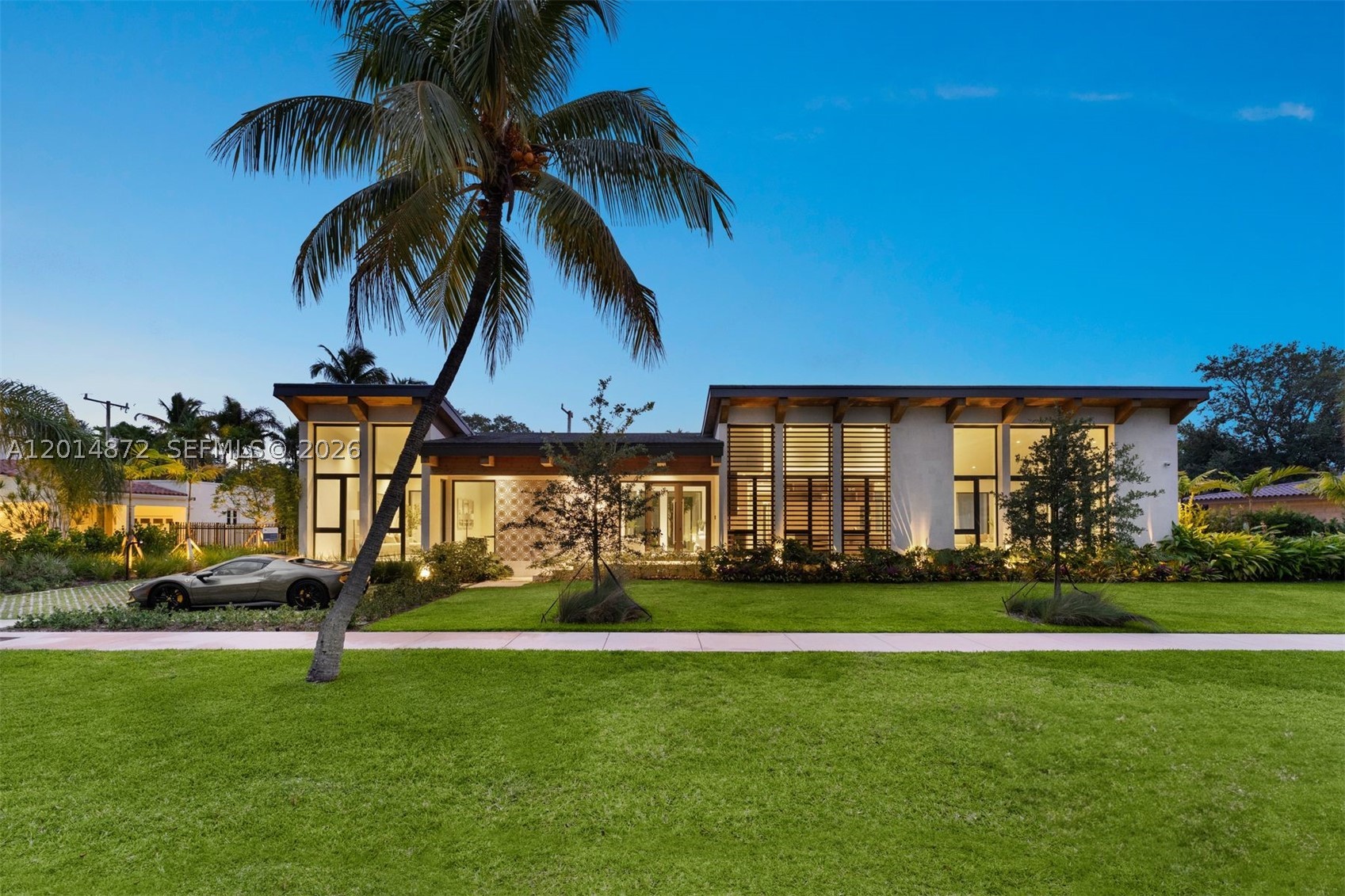 Some homes are designed to impress. Others are designed to make you feel something the moment you arrive. 6716 San Vicente does both with quiet confidence. Conceived by award-winning Shulman + Associates, San Vicente House draws inspiration from the great Mediterranean patio homes and relaxed modernism of mid-century California estates. Inside, timeless materials and an unmistakable sense of serenity define the experience of San Vicente House. At every turn, the home opens outward. Walls of glass disappear into lush outdoor spaces, blurring the distinction between inside and out. Each space flows effortlessly into the next, creating a home that feels expansive yet intimate. Fitted with La Cornue, the culinary experience is anchored for true epicurean chefs, while every suite is framed with lush garden windows and soaring ceilings. The result is a complete smart home that feels both intimate and expansive, designed as much for slow mornings as it is for elegant entertaining. A drive court allows recreational space and opens to the car port, providing a second entrance to the home. Set along one of Coral Gables’ most historic streets envisioned by George Merrick, perfectly located adjacent to Coconut Grove, Country Clubs, and beyond, San Vicente House blends architectural heritage with a refined, modern sensibility. A rare expression of Coral Gables living where light, architecture, and heritage come together in with the art of living well.