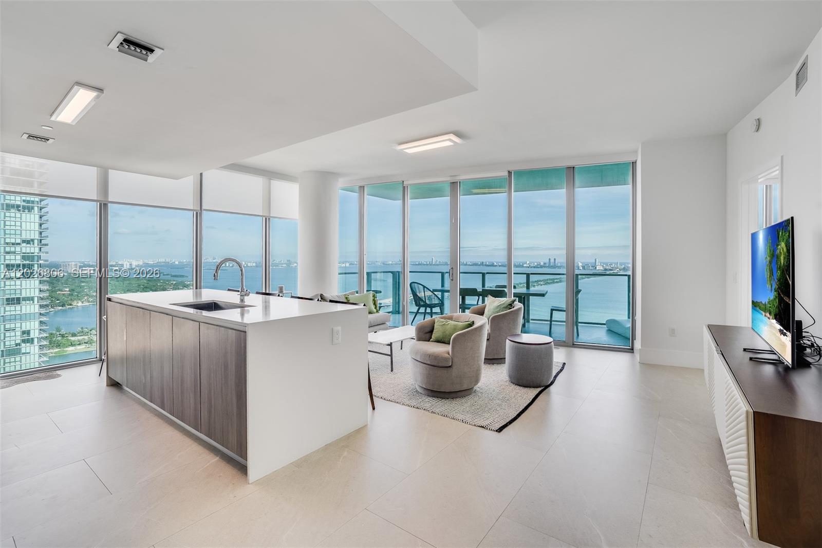 Discover unparalleled luxury in this exquisite corner residence at Biscayne Beach. Boasting 3 bedrooms + den, and 4 bathrooms with a private elevator, this spacious unit is adorned with sophisticated furnishings and offers breathtaking panoramic views. Located in the lively Edgewater area, it provides convenient bay access and an impressive array of resort-style amenities. Residents can enjoy the exclusive Beach Club & Lounge, unwind in two sparkling pools, or engage in sports at the Tennis and Basketball courts. Additional features include a soothing Spa & Hot Tub, a serene Sauna, Massage suites, and a state-of-the-art Fitness Center.