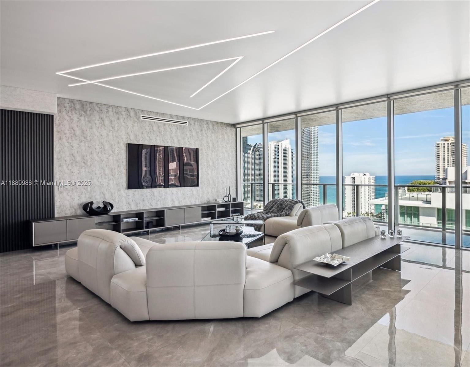 This stunning, state of the art Upper Penthouse is the epitome of turnkey luxury, w/4BR+Den & 5BA, spanning nearly 5,000sf of living space (3,877sf interior+1,011sf wrap around balcony) just steps from the beach. Professionally designed by Intero Futuro to provide an unparalleled living experience. Open layout with stretch ceilings and ultra-modern, linear LED lighting. Floor to ceiling windows with breathtaking views of the ocean, intracoastal and city skyline. Customized closets and a curated collection of luxury Italian furniture. Top-tier chef’s kitchen, Wolf/Sub-Zero/Bosch appliances with marble+adamantium quartzite countertops. Spacious primary suite with stunning ocean views, designer walk-in closet and a spa-like bathroom that creates a serene and lavish escape.
