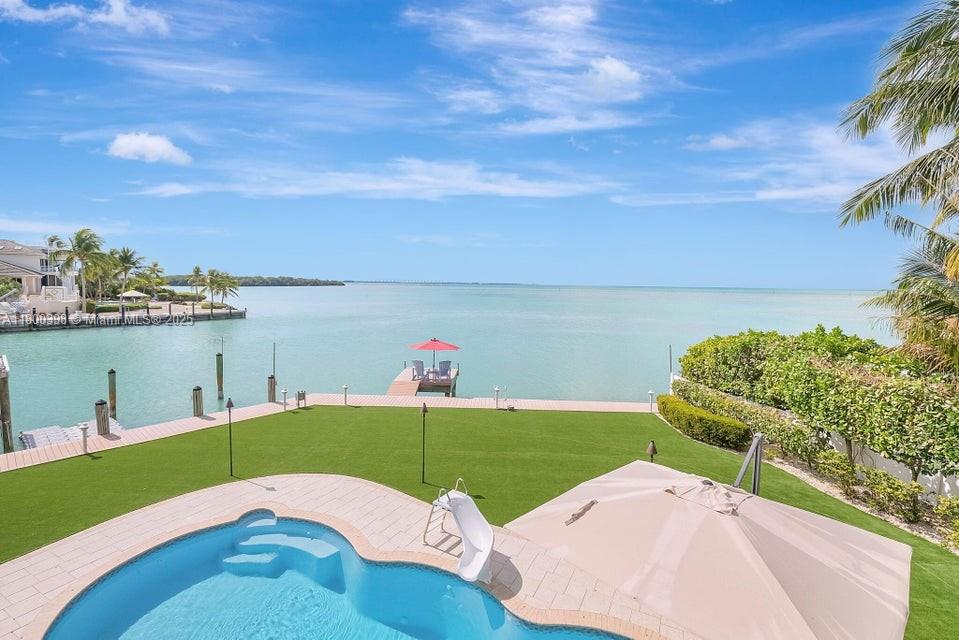 Nestled in the Safety Harbor enclave, Islamorada, this stunning Gulfside estate offers unparalleled blend of luxury and tranquility. Situated on a prime point w/open water and protected dockage, makes this a boater's paradise. With concrete seawall/2 boat lifts this home is appointed for waterfront living. Easy ocean access through Channel 5. Home features 8 ensuite BRs plus 2 half BAs. The master layout, a private sanctuary w/spa bath, showcases water views thru impact windows/sliding doors. Elevator ensures access to all levels; balconies invite you to savor unobstructed panoramas. The gourmet kitchen w/high-end appliances/gas cooktop is a chef's delight.  With its seamless indoor-outdoor design and unmatched location, this property is the epitome of luxurious Keys living. Owner/Agent