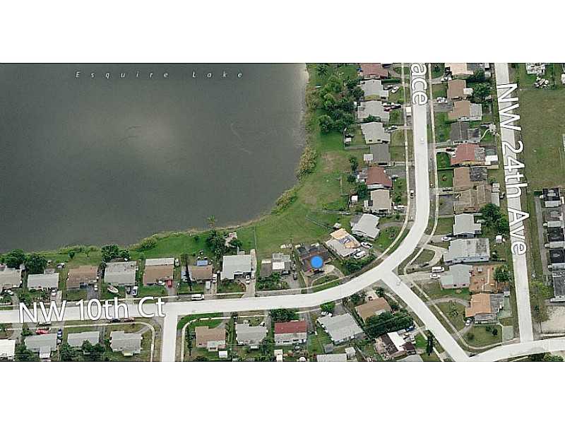 Bright & spacious 3/2 plus extra bonus den, looks out onto wide lake, circular driveway, laundry and storage room