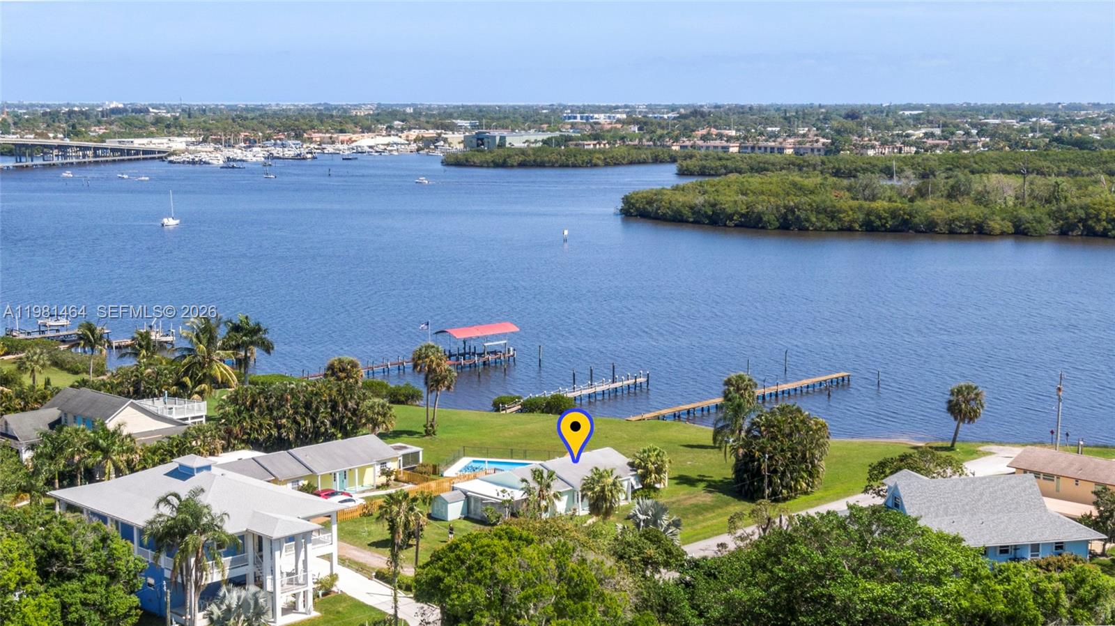 A 1000' expanse of calm protected open water.   Not a canal.  Not lakefront. Not a narrow inlet.  Just outside your back door lies a panoramic view of the gorgeous St Lucie River. The property faces a nature preserve, where your views will always be protected.  No looking across to condos, or your neighbor's backyard, or boat, or living room, through the back windows.  Just serene beautiful wide water with 70' of owned waterfront and full riparian rights.   For boaters there is a permitted dock, (unbuilt,) and direct access to the ocean with no fixed bridges and storm-sheltered dockage.  For rowers, paddleboarders, kayakers the protected calm waters are perfect.  The 2 bedroom 2 bath house has a charming interior, light and open with great views to the river.  Completely remodeled. Livable now, buildable later.  This is the only house on wide open waterfront priced under $1.2 million from Stuart to Miami.  Further south waterfront is unobtainable at this price.