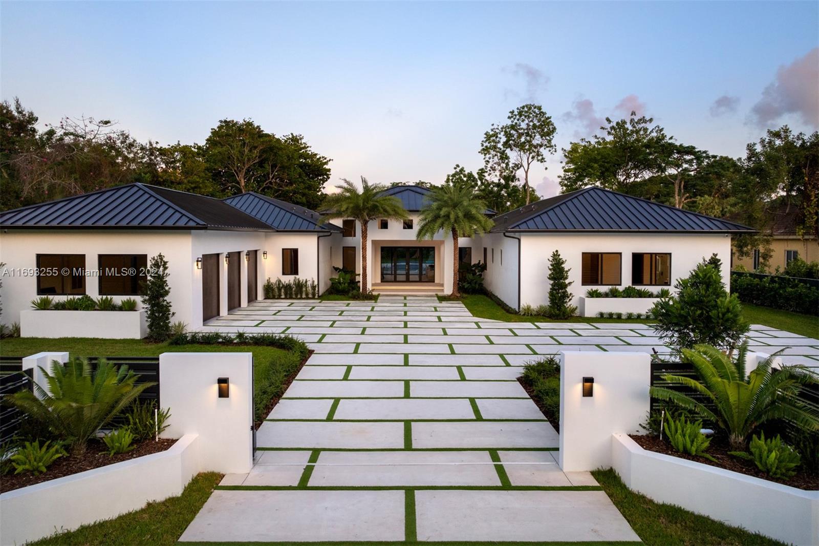 Discover a 2024-built tropical oasis situated on an expansive 39,814 SqFt lot. Inside, Italian porcelain tiles extend throughout, while large impact glass windows fill the home with natural light & showcase picturesque views of the lush landscape. The kitchen fts. fully integrated Miele appliances, 10’ Italian custom cabinetry & durable porcelain countertops. Recessed LED lighting elegantly accents the cabinetry, while a wine cellar completes this chef’s haven. The primary ste offers a peaceful retreat with a private office or sitting area, direct pool access, & a spacious walk-in closet illuminated by LED lighting. Step into a backyard paradise surrounded by lush green artificial turf, showcasing a sparkling pool with an adjoining hot tub & a versatile court for Pickleball and basketball.