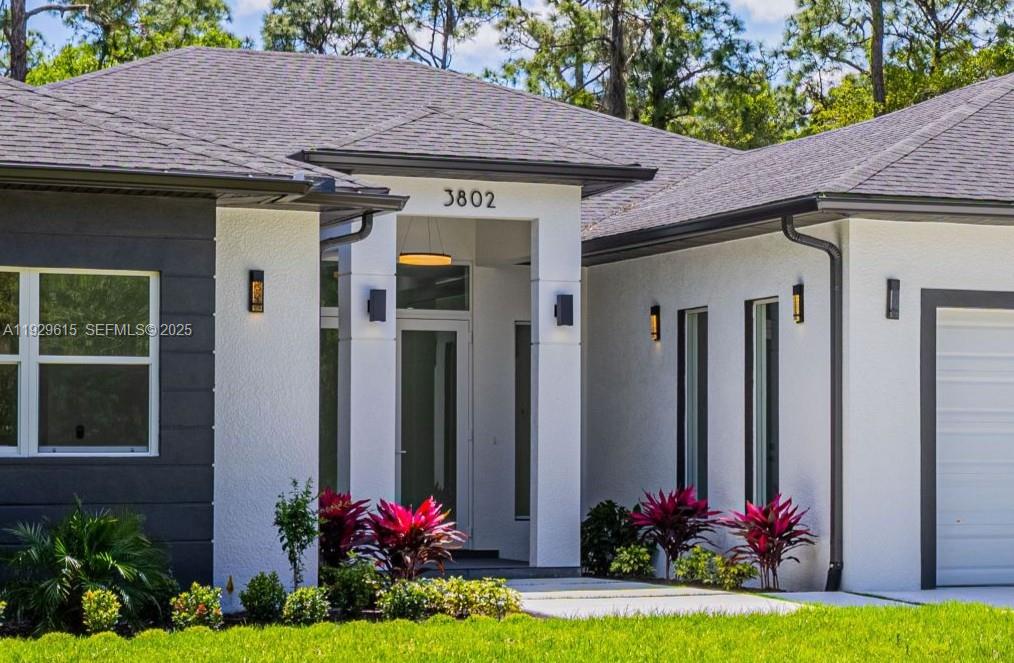Imagine waking up in a serene paradise where the beauty of nature merges with modern luxury. Welcome to Golden Gate Estates, a neighborhood of large lots located between Miami and Naples, one of the fastest-growing areas in South Florida. Situated on a 2.73-acre lot with no wetlands, this unique design by Terranova Construction Group redefines elegance and sophisticated living. It features four spacious bedrooms, three full bathrooms and a half bath, plus a large living room and a cozy family room connected to the gourmet kitchen. A bright laundry area and a two-car garage with extra space for a utility vehicle and an electric vehicle charging outlet. High-quality finishes include elegant impact-resistant windows, 24x48 tile flooring, glass shower enclosures, and modern cabinetry in the closets. Outside, relax on the concrete driveway and covered back patio, with ample green space ready for your dream pool. A deep well and modern reverse osmosis system provide pure water. The zoning allows for the construction of a guesthouse or additional secondary structure. This is a retreat that combines privacy and an excellent central location. Located in a rapidly developing real estate area with high appreciation potential, and with no restrictions or HOA fees, this is more than a house: it's an opportunity to invest in your lifestyle and your future. Discover the perfect balance of modern design and natural tranquility today; every detail exceeds expectations. Your dream home awaits!