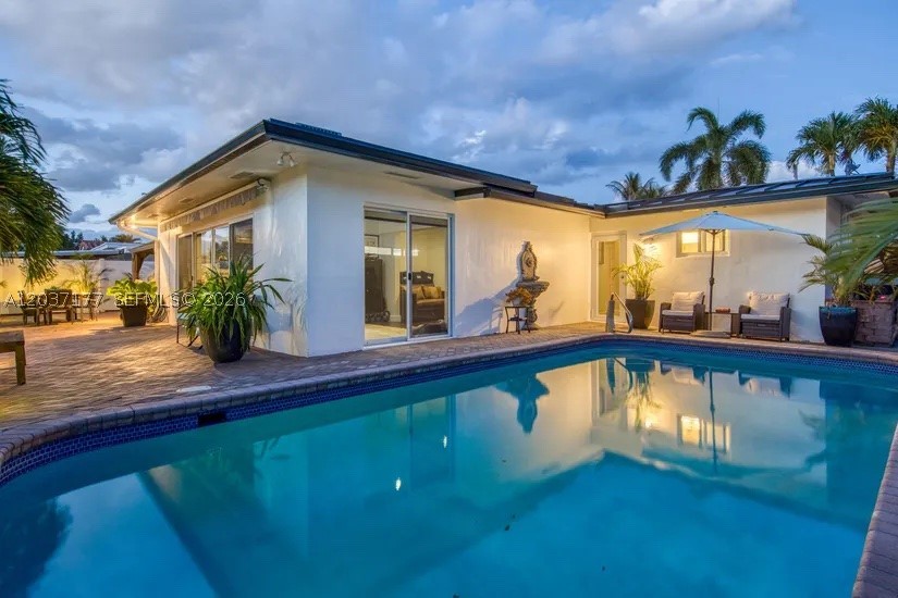 Beautifully updated & designed, this waterfront home offers the perfect balance of comfort, privacy & boating convenience. Ideally positioned near the mouth of the canal for quick access to open waterways, this exceptional property features 70 feet of waterfront, a private dock with dual electrical service, a 14,000-lb boat lift with remote controls, and a well-maintained seawall. Designed for both everyday living and entertaining, the open-concept floor plan centers around a spacious kitchen with granite countertops, custom wood cabinetry, stainless steel appliances, a modern hood, and generous bar seating. Bamboo flooring and custom window treatments add warmth and style throughout. The split-bedroom layout provides privacy, while the primary suite features a walk-in closet and dual-sink bath. Step outside to your own private retreat featuring a heated saltwater pool, pergola cabana, retractable awning, lush tropical landscaping, and custom outdoor lighting. Bedrooms offer convenient access to the patio and pool area, creating seamless indoor-outdoor living.
Recent upgrades include a new metal roof (2025), full impact windows and doors, a new 5-ton A/C system (2025), and updated electrical wiring. Additional highlights include a 2-car garage, paver driveway with parking for four additional vehicles, indoor laundry room, outdoor shower hookup, and a secure landscaped courtyard.
Located on a quiet street just minutes from Wilton Drive’s dining, shopping, and entertainment.