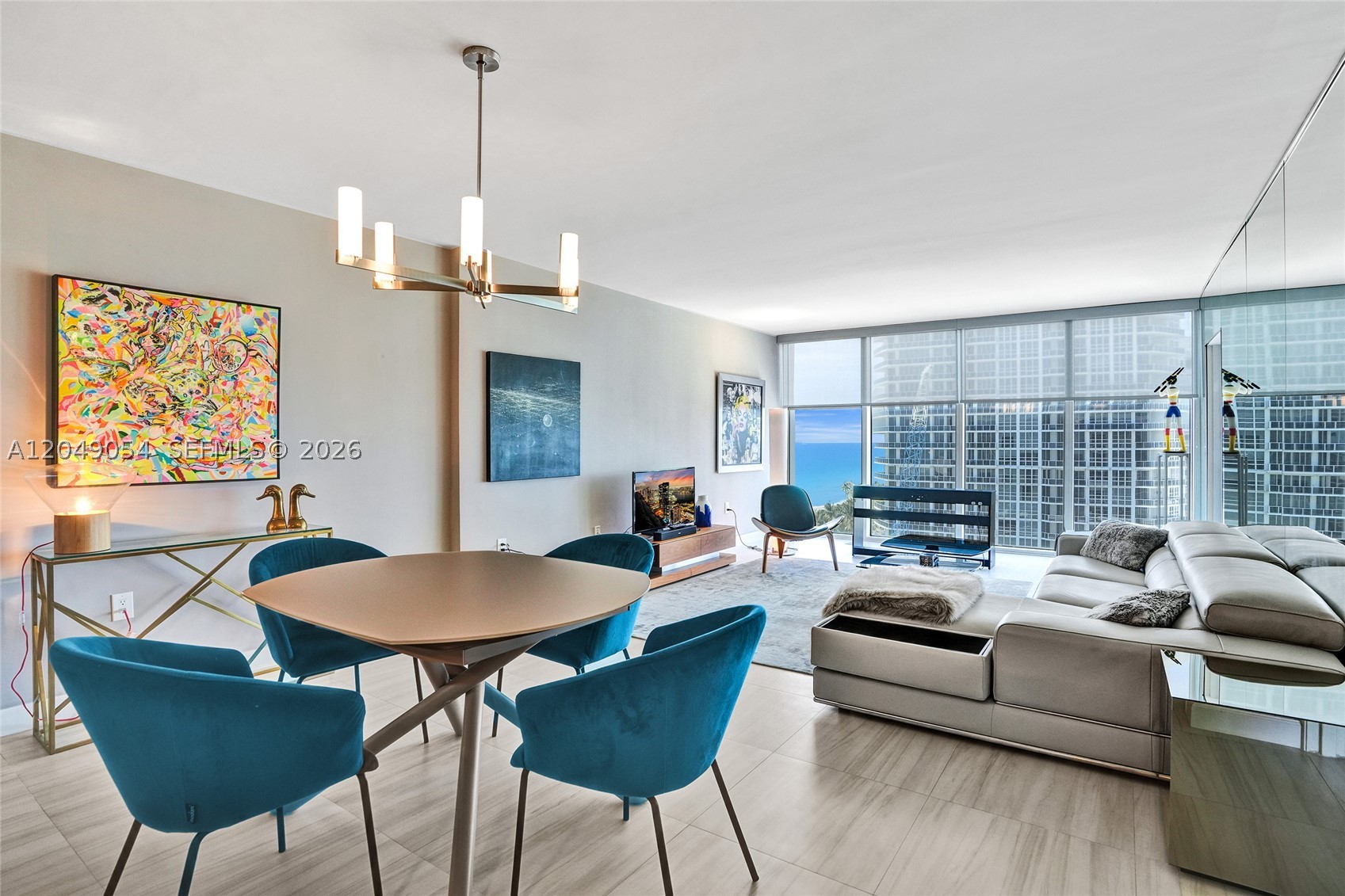 Beautifully updated 1-bedroom, 2-bath residence in the prestigious Harbour House, one of Bal Harbour's premier oceanfront communities. This spacious unit features an open-concept floor plan with a large chef's kitchen, granite countertops, generous island, stainless steel appliances, full-size washer and dryer, and abundant storage. The renovated primary bathroom offers a double vanity and oversized walk-in shower with a sleek contemporary design. Floor-to-ceiling impact glass fills the home with natural light and opens to a private balcony with beautiful ocean, skyline and city views. Designer finishes, large-format porcelain tile flooring, and a full mirrored accent wall enhance the bright, expansive living space. Harbour House offers exceptional resort-style amenities including direct beach access with beach service, oceanfront pool, fitness center, spa, sauna, café, valet, concierge, business center, social room, and 24-hour security. Ideally located just minutes from Bal Harbour Shops, world-class dining, Surfside, and everything Bal Harbour has to offer. An exceptional opportunity to enjoy luxury beachfront living in one of South Florida's most sought-after addresses.
