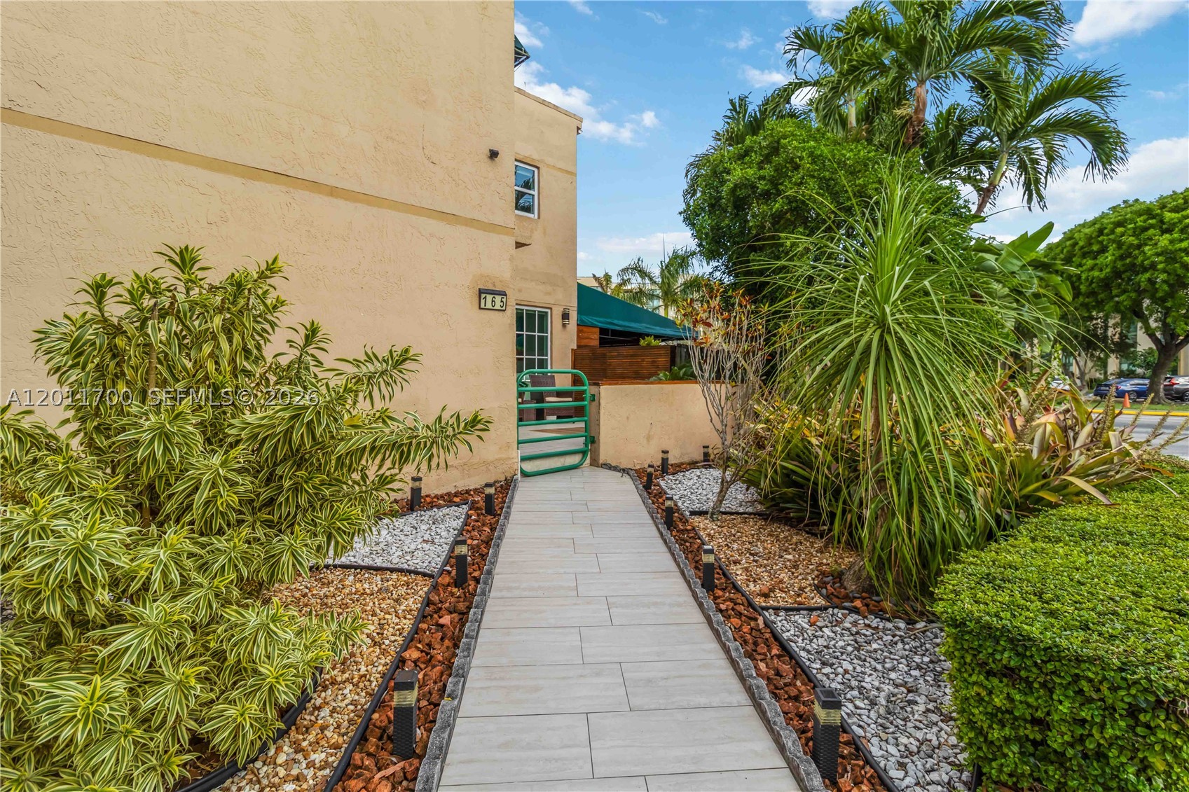 This is the one! This 2-Bedroom, 2.5-Bath Townhome-Style Condo Near FIU – Ideal for Living or Investment!  Welcome to this bright and inviting two-story condo offering 1,210 square feet of well-designed living space. While officially a condo, the layout lives like a private townhouse, giving you both comfort and separation between living and sleeping areas.  The main level features an open living and dining area filled with natural light, a convenient half-bath, and a seamless flow perfect for entertaining. The home has been tastefully updated with light-toned flooring reminiscent of travertine and a modern accent wall that adds warmth and character throughout. Step outside to enjoy your own outdoor cooking space—perfect for gatherings or relaxing evenings.  Upstairs, you’ll find two generously sized bedrooms, each with its own en-suite bathroom, providing privacy and functionality for residents or guests. Built in 1989, the property offers a practical floor plan with timeless appeal.  Centrally located near FIU, major highways, shopping centers, and dining options, this home is positioned in a growing and highly desirable area. Whether you're searching for a primary residence, a student-friendly setup, or a strong rental opportunity, this property is a standout choice.