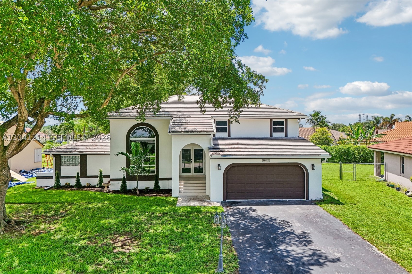 Discover this beautifully renovated 4-bedroom, 3.5-bathroom home with a spacious loft and large balcony overlooking a serene lake, situated on an oversized lot of more than ¼ acre in the highly sought-after Ivanhoe community of Davie. This stunning residence with 2,648 square feet under air, has been completely updated and features a brand-new kitchen with white shaker cabinetry, elegant Taj countertops, and new Samsung appliances. All three and a half bathrooms have been thoughtfully remodeled with modern finishes. 
The home showcases a new striking glass staircase, new luxury vinyl flooring throughout, 6-inch baseboards, recessed lighting, new interior doors and molding, separate laundry room with new washer and dryer and fresh interior and exterior paint. Additional major improvements include a 2018 ROOF with solar panels, FULL IMPACT WINDOWS AND DOORS, and two air conditioning units installed in 2021 and solar water heater as well full concrete block construction including the second floor providing comfort, efficiency, and peace of mind. The spacious first-floor primary bedroom is designed to provide both convenience and a sense of privacy.
Enjoy tranquil lake views from your balcony and the privacy of a spacious backyard with plenty of room for a pool in a quiet, family-friendly neighborhood. Conveniently located near parks, shopping, major highways, and top-rated A schools, this exceptional home offers the perfect blend of luxury, style, and location.