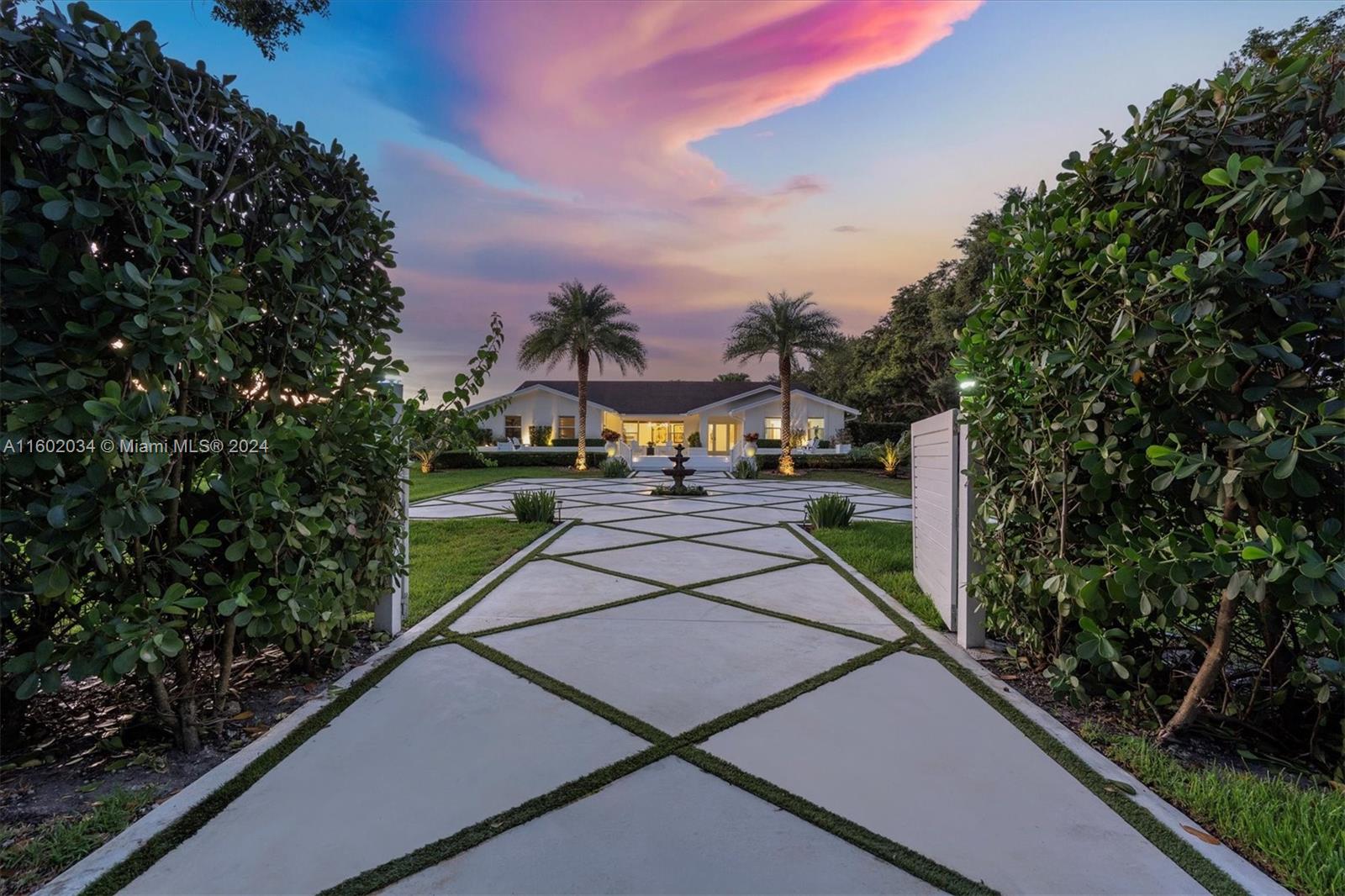 Welcome to one of the finest grand estates with a separate guest home. Enter through the gates and be whisked away to your own secluded oasis. This perfect home on over an acre features an open floor plan connecting formal living, family, dining, and kitchen areas. The chef's kitchen is a masterpiece with a Thermador 6-burner gas stove/griddle, double oven, wine fridge, and quartzite natural stone countertops. Newer roof, impact windows & doors, with each home offering a two-car garage. The guest home, with a separate entry, offers 2 beds/1 bath, a family room, & full kitchen. Enjoy a serene & private atmosphere w/ stunning landscaping that creates a zen-like ambience that is truly unmatched. Prime location 15 miles from Ft. Lauderdale & airport, near highways, beaches, dining, & shops.