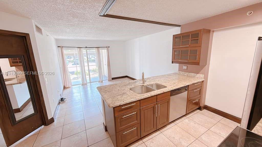Large 2 bed/1 bath on the first floor. Open kitchen with granite countertop and stainless appliances , large screened in patio with washer/dryer. Condo located in a gated community with pool, jacuzzi, spa, fitness, racquetball, and club house. Easy access to I-95 and the turnpike, downtown Hollywood, the Hard rock Hotel and Casino and more. Located across from a golf course with plenty of green space! (SEE BROKER REMARKS)