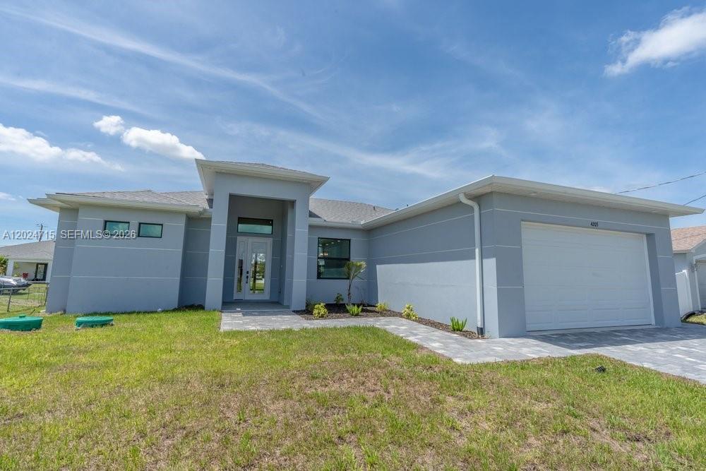 Invest in Your Dream Home! Welcome to this newly built 3 bedroom, 2 bath modern home designed for family living. As you arrive, you will be greeted by a beautiful paver driveway leading to the 2 car garage. Upon entering the home, you will be captivated by the 10’ ceilings and open concept floor plan that seamlessly combines the family room, kitchen, and dining room areas with porcelain tile, creating a spacious and inviting atmosphere. The kitchen is fully equipped with stainless steel appliances, including a refrigerator, dishwasher, range, and microwave, quartz countertops, and a center island with sink and cabinets. The laundry room is equipped with a full sink and cabinets, providing ample space for a washer and dryer. The guest bedrooms feature wood flooring and share a bathroom with a tub/shower combination. The master suite boasts wood floors, a separate soaking tub & shower, his & her sinks, and 2 walk-in closets. This home also includes impact windows and doors for added peace of mind. Step outside to the open porch lanai with tile flooring, perfect for entertaining. If a swimming pool is in your dream home's future, there is plenty of room to make it a reality. This home comes with a 2-10 New Home Warranty, providing you with additional assurance and peace of mind. Don't miss out on the opportunity to make this dream home yours! Don't miss out on the opportunity to make this dream home yours!