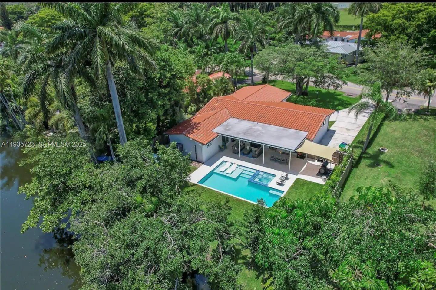 Entertainer's Paradise in El Portal! This 4BR/2BA, 2,400 sq. ft. canalfront home boasts an open-concept layout with a stylish kitchen featuring quartz countertops. A custom heated saltwater pool with an independent Jacuzzi, beach-entry design, and app-controlled technology for effortless enjoyment.  While the canal does not allow ocean access, it's perfect for paddle sports, relaxation, and serene waterfront living. Located in an Airbnb-approved area, this home combines lifestyle and investment potential.