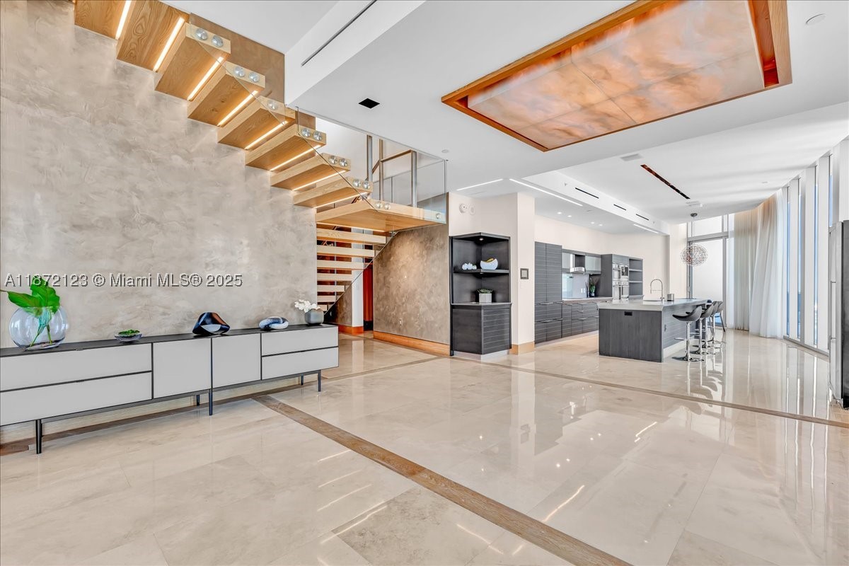 A House In The Sky with over 7000 sq ft! This extraordinary 2-Story PH spans over 4300 living sq ft & 2700 balcony sq ft with east panoramic views of Biscayne Bay & Ocean. Ideal for indoor & outdoor living with 5 balconies including a rooftop terrace and your very own private plunge pool. Features include a floating illuminated staircase, open chef’s kitchen with high-end Miele appliances, custom closets/doors, Tesla Charger & 2 oversized storage units. Primary suite w/spa-like marble bath & soaking tub. The 2nd floor is your ultimate entertainment center that can be converted into a 4th bedroom or in-law suite.  Epic Residences is conveniently located minutes from Brickell, Bayfront, & One World Center. This is truly a House in the Sky!