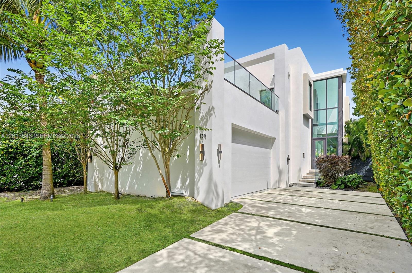 A striking modern masterpiece on prestigious Bay Drive in Normandy Isle, this newly constructed Miami Beach enclave blends architectural sophistication with effortless luxury. Featuring 5 bedrooms & 5.5 baths, the home showcases soaring volume ceilings, floor-to-ceiling impact glass, imported Italian porcelain floors, motorized shades and a seamless open-concept design drenched in natural sunlight. The designer kitchen is appointed with a premium Bosch appliance package, custom cabinetry and an expansive island and breakfast bar while a whole-home Sonos system creates an elevated living experience throughout. The lavish primary suite offers a private balcony, oversized dual closets, and a spa-inspired bath with Duravit & VIGO fixtures. Outdoors, a heated pool and expansive entertaining areas evoke resort-style living, complemented by a rooftop deck finished with synthetic grass and lush tropical ambiance. Situated on exclusive Bay Drive, a rare cul-de-sac on both ends, 1311 Bay Drive offers tranquility and privacy in burgeoning North Beach just minutes from the beach, beautifully redesigned Ocean Terrace, and the iconic Normandy Isle Fountain and Farmers Market. The location is perfect, an easy drive to Miami Country Day, Temple Beth Sholom & Moses, North Beach Elementary, and The Cushman School, while only minutes from the celebrated boutiques, fine dining, and coastal sophistication of Surfside & Bal Harbour. This property is an absolute gem. Call today for a private tour.