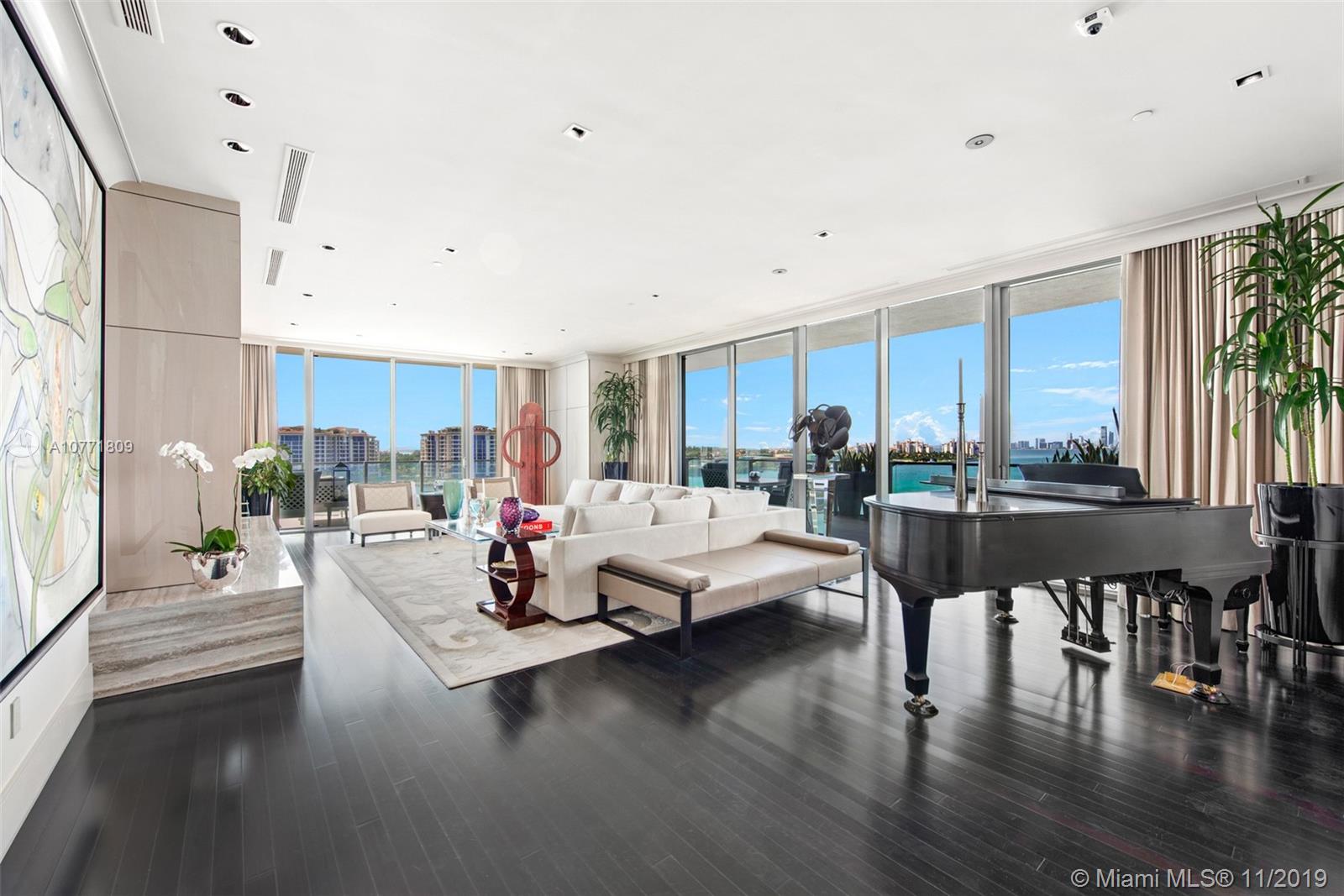 Enjoy unparalleled city bay & ocean views from this highly coveted WEST facing apt in SOFI's most prestigious bldg. Apogee, this highly customized 4BR jewel has 4,154 SF of living space & 2,441 SF of terraces per attached flr pln. Features include private entry foyer w/mother of pearl walls, entrance hall w/arched ceilings, grand entertaining areas w/Wenge wood flrs, motorized blinds & drapes, flr to ceiling impact glass doors, surround sound, special art lighting, formal LR w/FP & blt ins, cozy media rm w/leather walls & sound proofing,eat-in kitchen w/high end appliances,gas cooktop & wine chiller. Partial marble wall divider w/retractable TV separates formal DR from kitchen,spacious master suite w/walk in closet,drsg area,oversized bth & addt'l half bath w/bidet. Private 2.5 A/C garage.