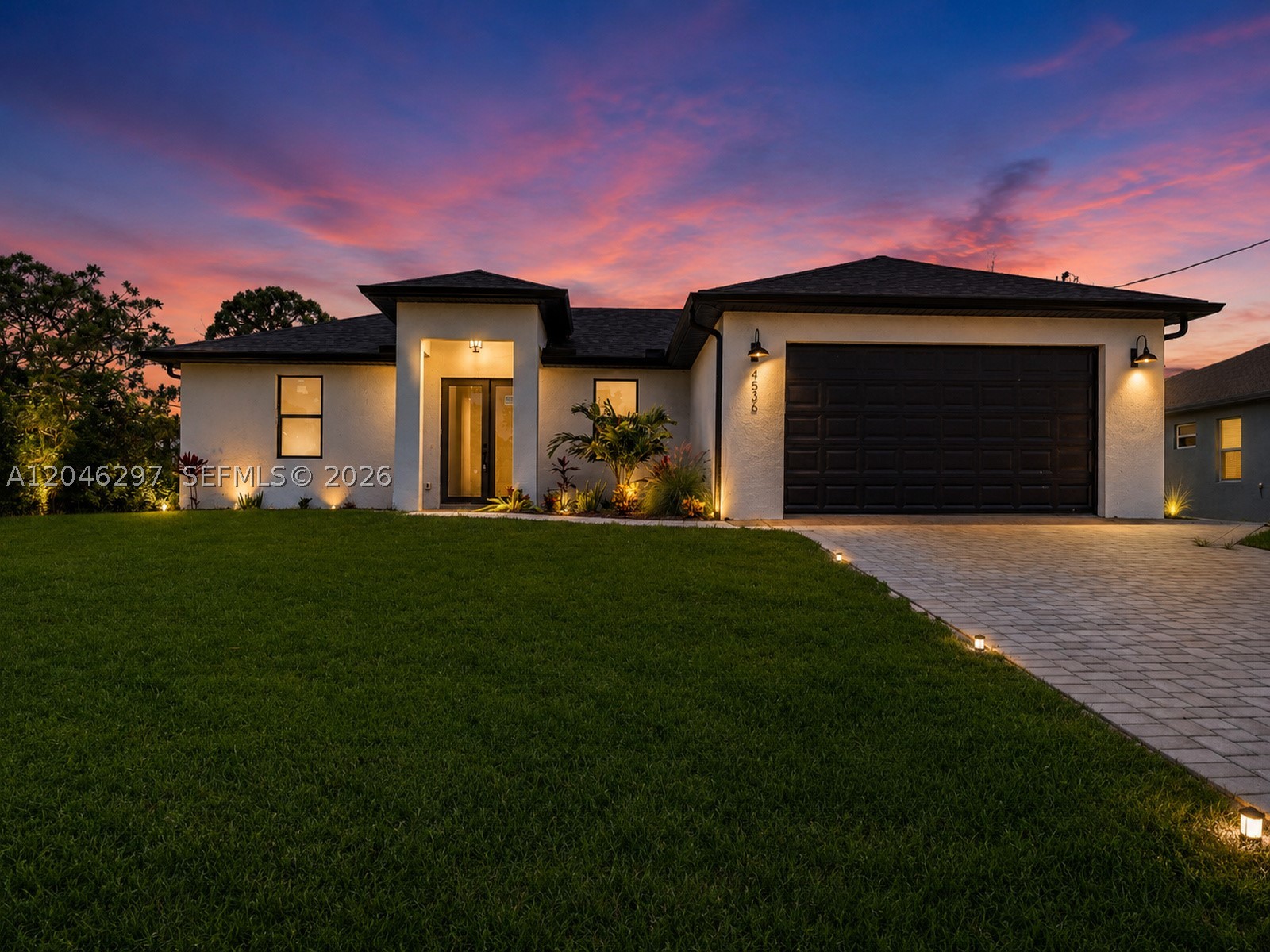 Welcome to the Moon Model, a beautifully designed contemporary residence offering 3 bedrooms, 2 bathrooms, and 1,387 square feet of thoughtfully designed living space. Inside, you'll find soaring tray ceilings, oversized porcelain tile flooring, designer lighting, and an open-concept layout that seamlessly connects the living, dining, and kitchen areas. The kitchen features quartz countertops, custom cabinetry, a large center island, and matte black fixtures. The private primary suite offers walk-in closet and a spa-inspired bath with LED backlit mirrors, dual vanities, a frameless glass shower, and floor-to-ceiling tile. Step outside to a covered lanai overlooking a fully fenced backyard complete with a custom aluminum fence, paver patio, gazebo, and jacuzzi, creating the perfect space to relax or entertain. Additional highlights include impact windows and doors, an epoxy-coated two-car garage, and modern finishes throughout.