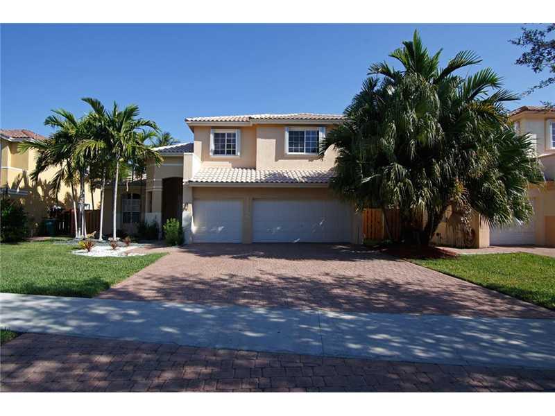 Magnificent contemporary home inthe exlusive Doral Isles. This lushly landscaped property features 5 bedrooms, 4 bath on an extra lot. Tiled floor in first floor level and laminated wood in second level. Enjoy the beautiful club house.